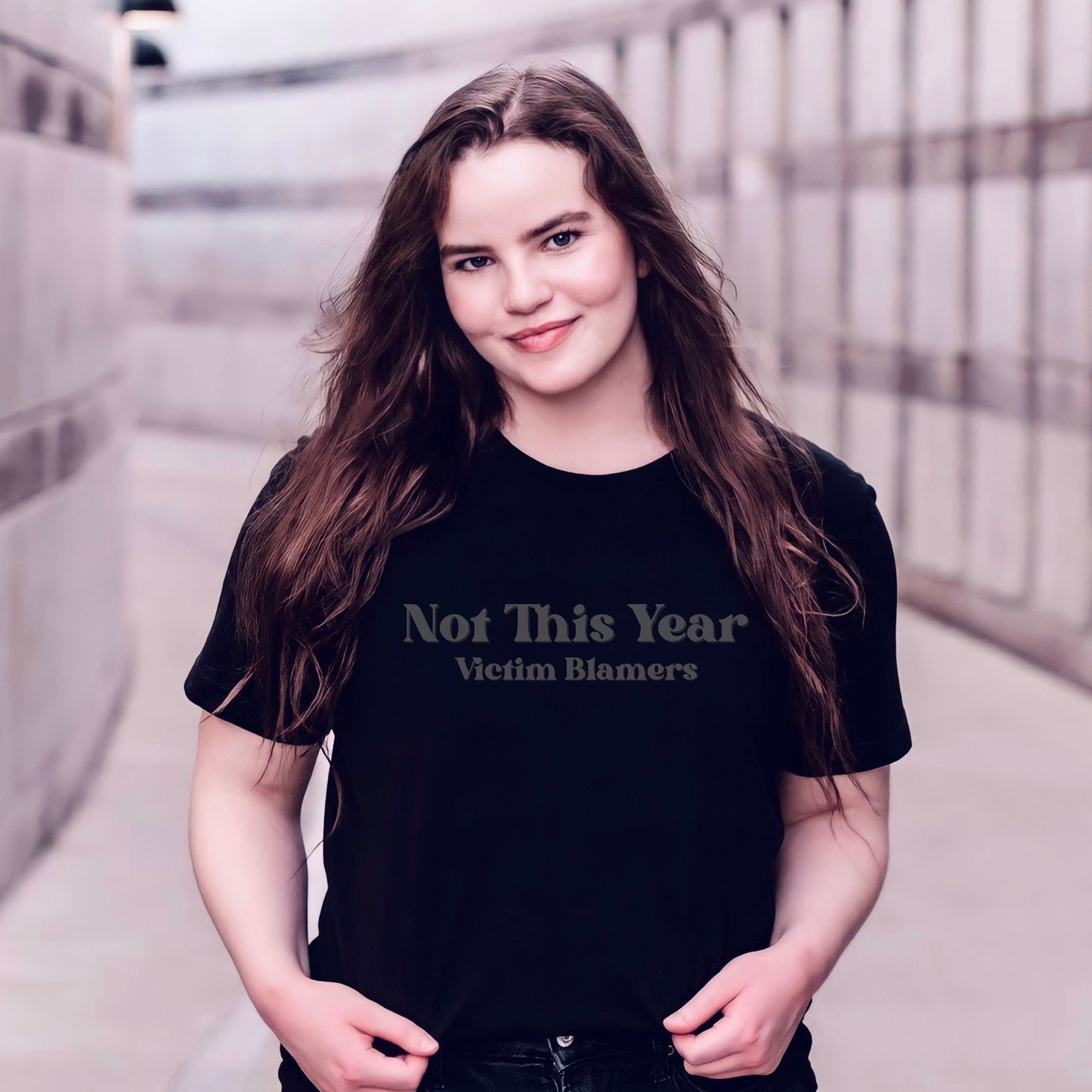 The front of the sweatshirt proudly displays the phrase "Not This Year Victim Blamers" in a bold and eye-catching font. This message serves as a reminder that we reject victim-blaming and support those who have faced injustice.