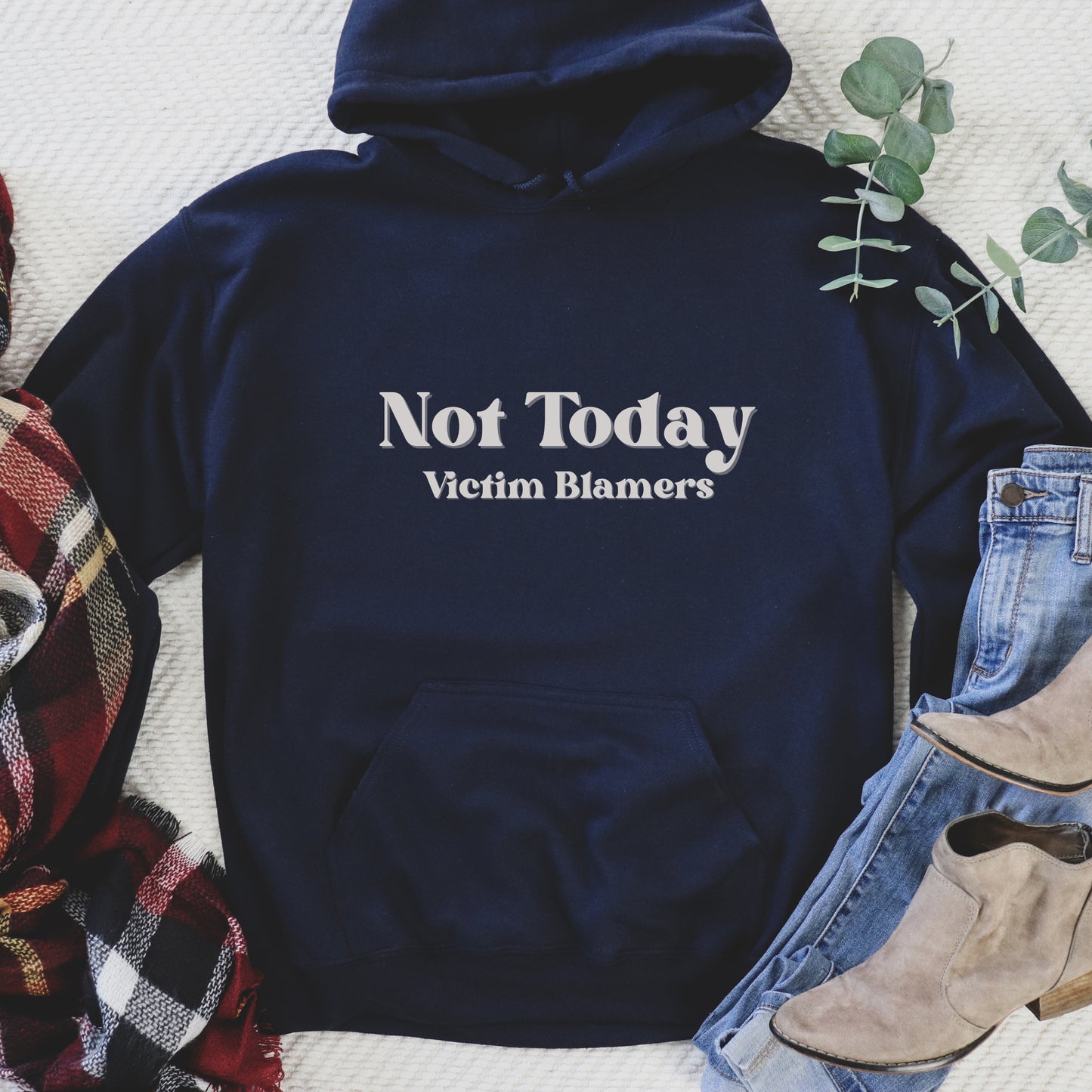 The front of the hooded sweatshirt proudly displays the phrase Not Today Victim Blamers in a bold and eye catching font. This message serves as a reminder that we reject victim blaming and support those who have faced injustice.