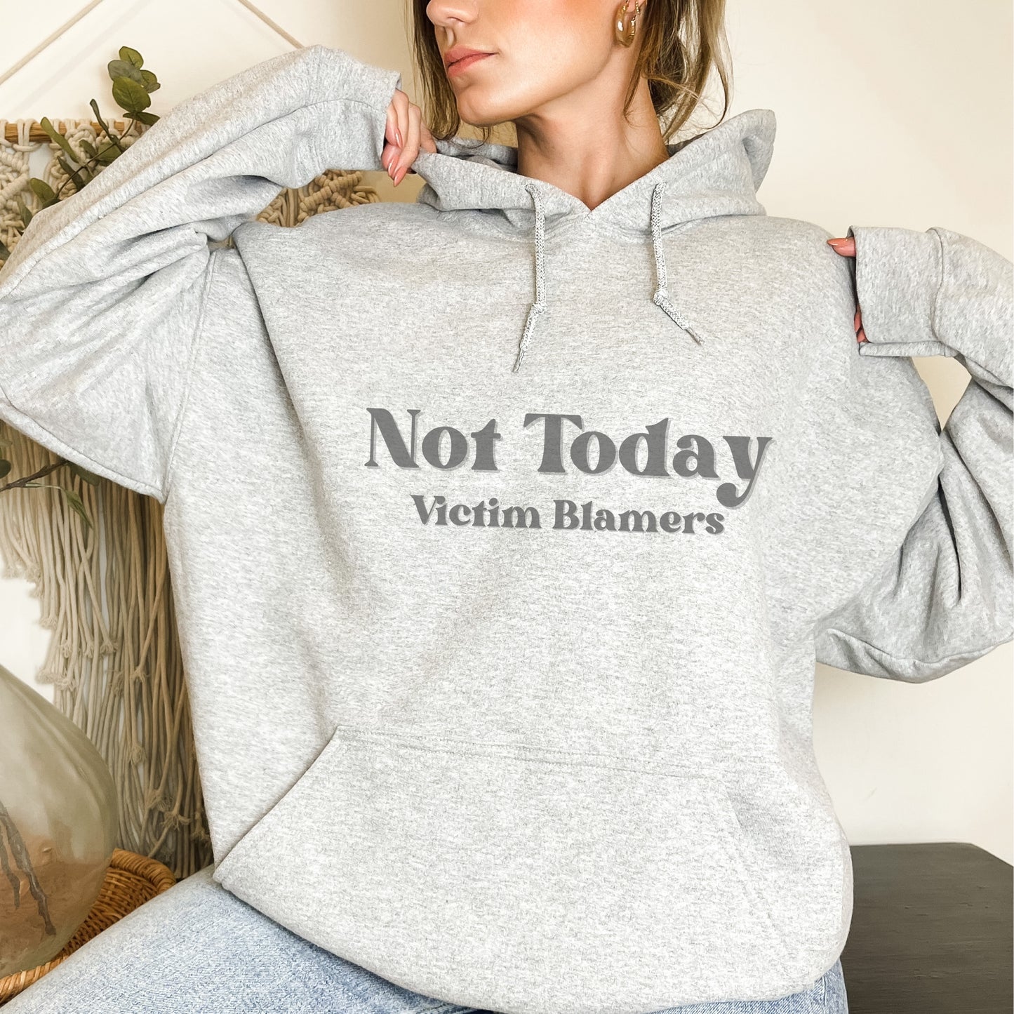 The front of the hooded sweatshirt proudly displays the phrase Not Today Victim Blamers in a bold and eye catching font. This message serves as a reminder that we reject victim blaming and support those who have faced injustice.
