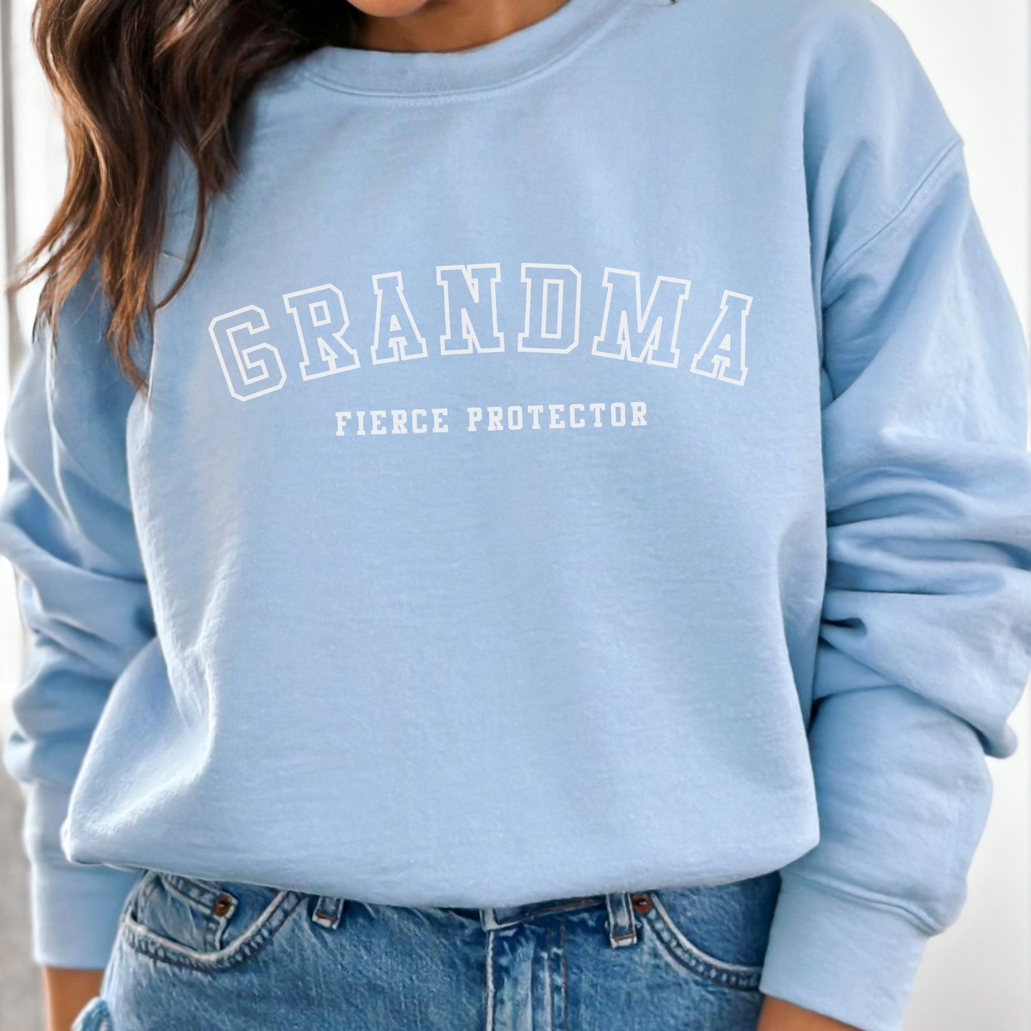 The front of the sweatshirt proudly displays the phrase Grandma Fierce Protector in a bold and eye catching font. This message serves as a reminder that we reject victim blaming and support those who have faced injustice. Your grandma can wear her strength proudly, embracing both comfort and empowerment.