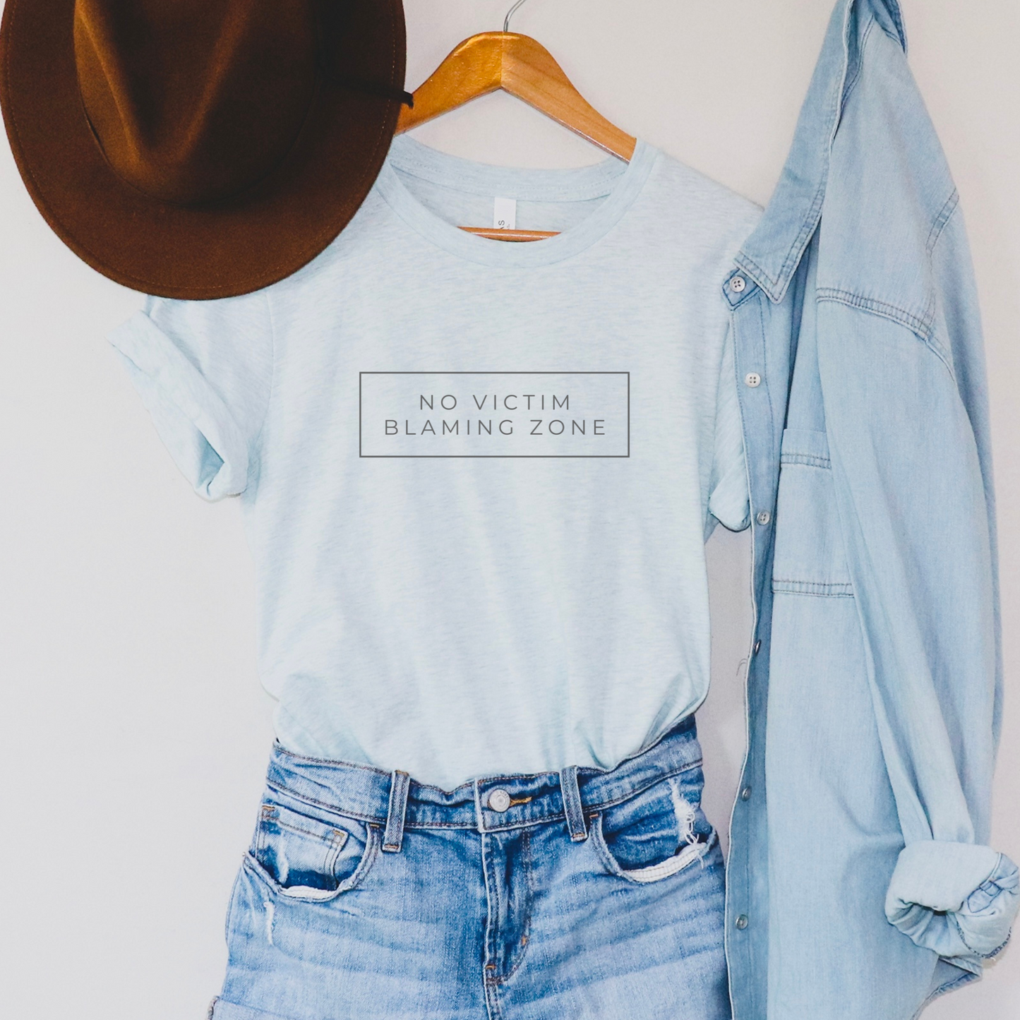 Soft Bella + Canvas Heather Ice Blue No Victim Blaming Zone shirt for survivor support, activism, and awareness.