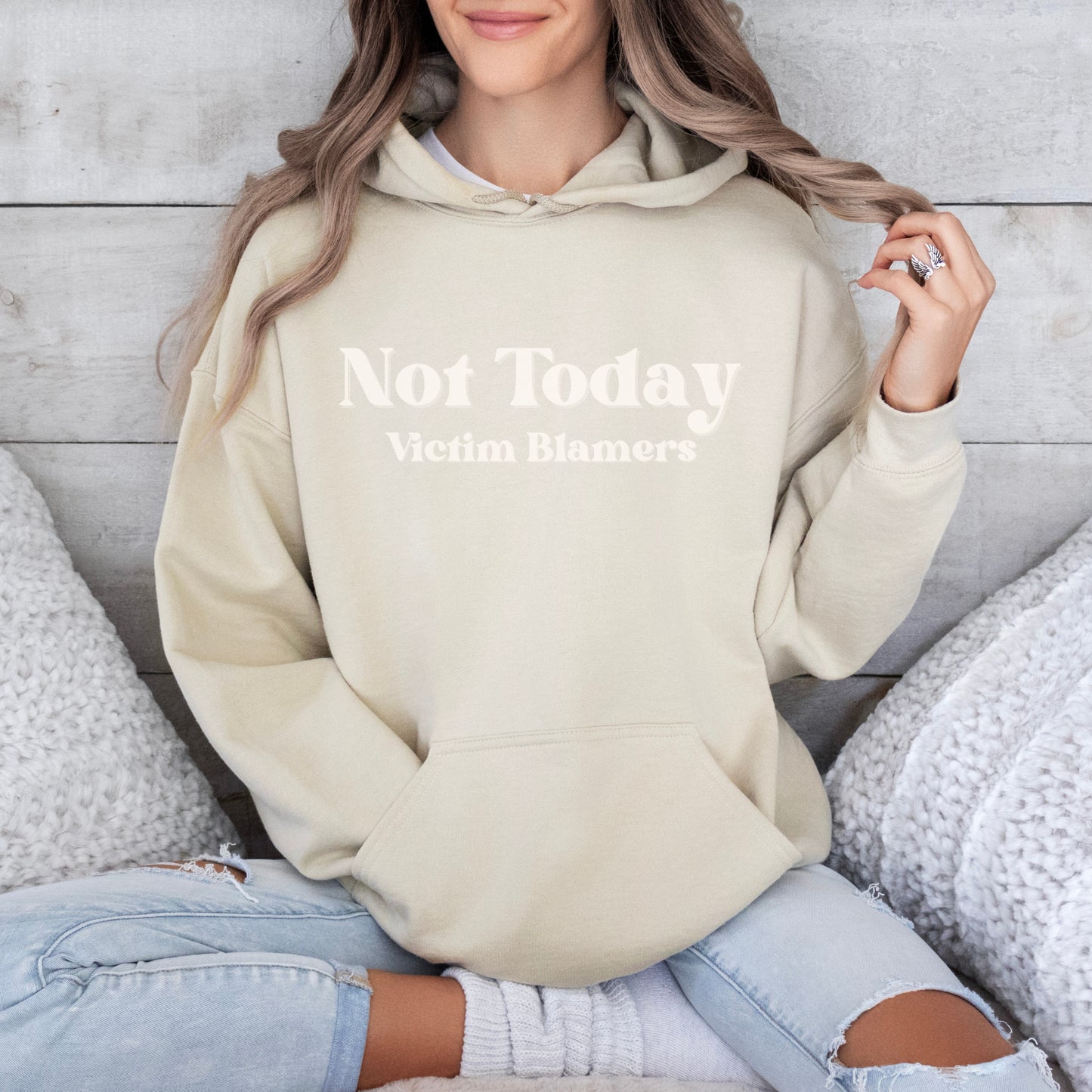 The front of the hooded sweatshirt proudly displays the phrase Not Today Victim Blamers in a bold and eye catching font. This message serves as a reminder that we reject victim blaming and support those who have faced injustice.