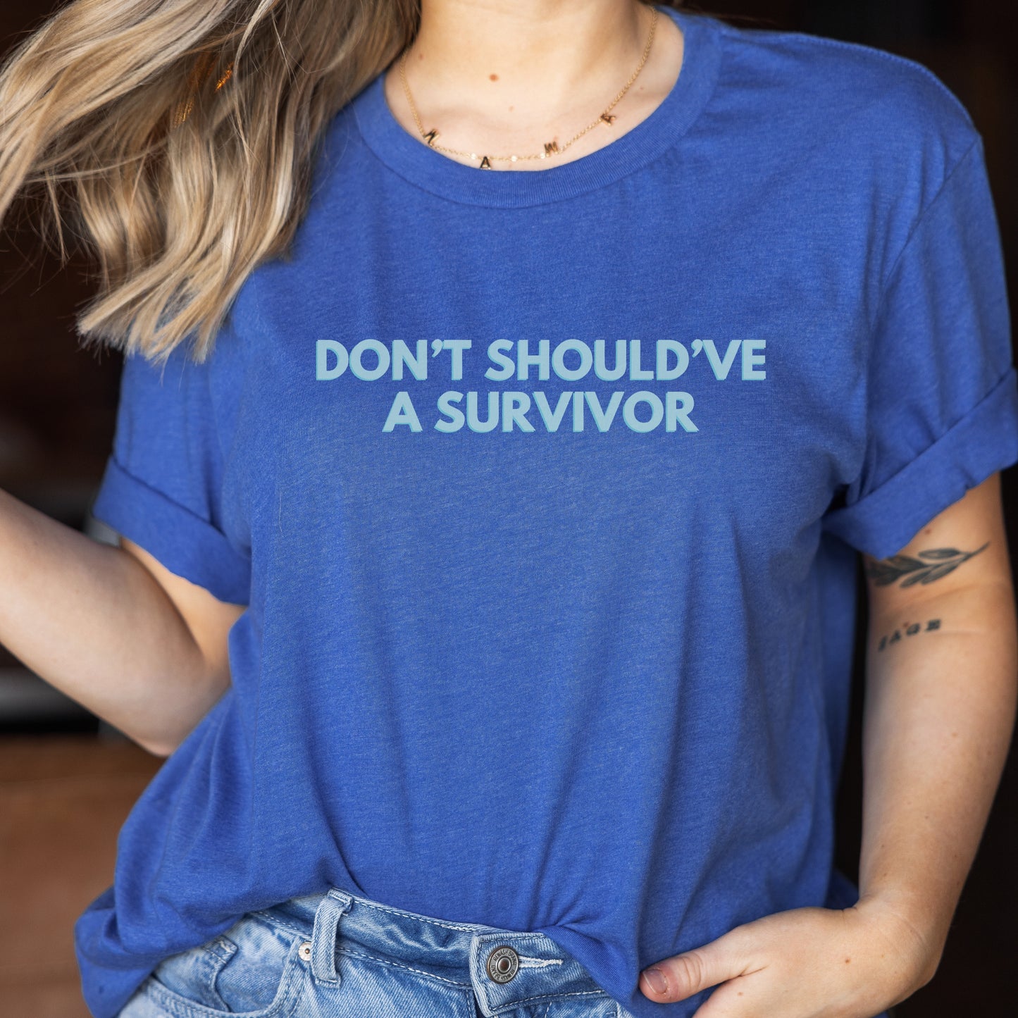 The front of the T-shirt has the empowering saying ‘Don’t Should’ve A Survivor’ and the back says Team Survivor SAAM with the teal awareness ribbon. Designed to support survivors and end victim blaming during April Sexual Assault Awareness Month (SAAM) and Denim Day. Perfect for survivors, child and victim advocates, and mental health advocates.