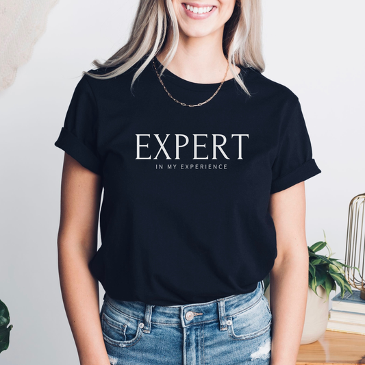 Expert in My Experience t-shirt in solid black blend with white text. Unisex Bella + Canvas empowerment tee for survivors and advocates.