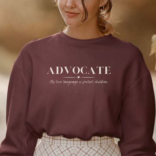 Front and center, the bold message declares, "ADVOCATE: my love language is protect children." This impactful phrase encapsulates the essence of your commitment to safeguarding children and promoting their well-being. Perfect for child advocates, champions of children’s mental health, and for Child Abuse Awareness and Prevention Month