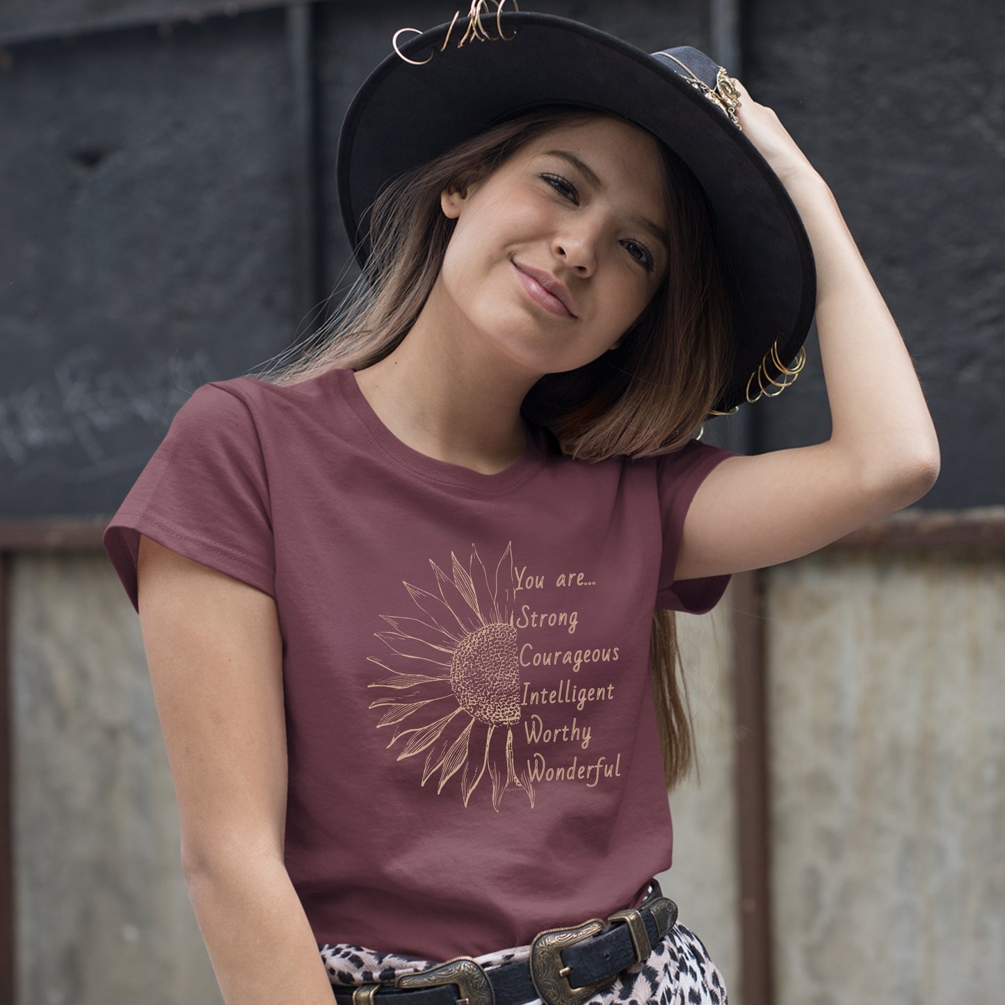 This thoughtfully designed shirt features a vibrant sunflower, symbolizing resilience and growth, accompanied by the powerful mantra: "You are strong, courageous, intelligent, worthy, and wonderful."