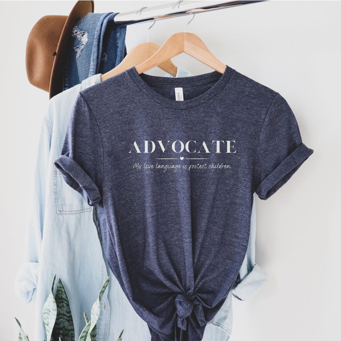 Front and center, the bold message declares, "ADVOCATE: my love language is protect children." This impactful phrase encapsulates the essence of your commitment to safeguarding children and promoting their well-being. Perfect for child advocates, champions of children’s mental health, and for Child Abuse Awareness and Prevention Month