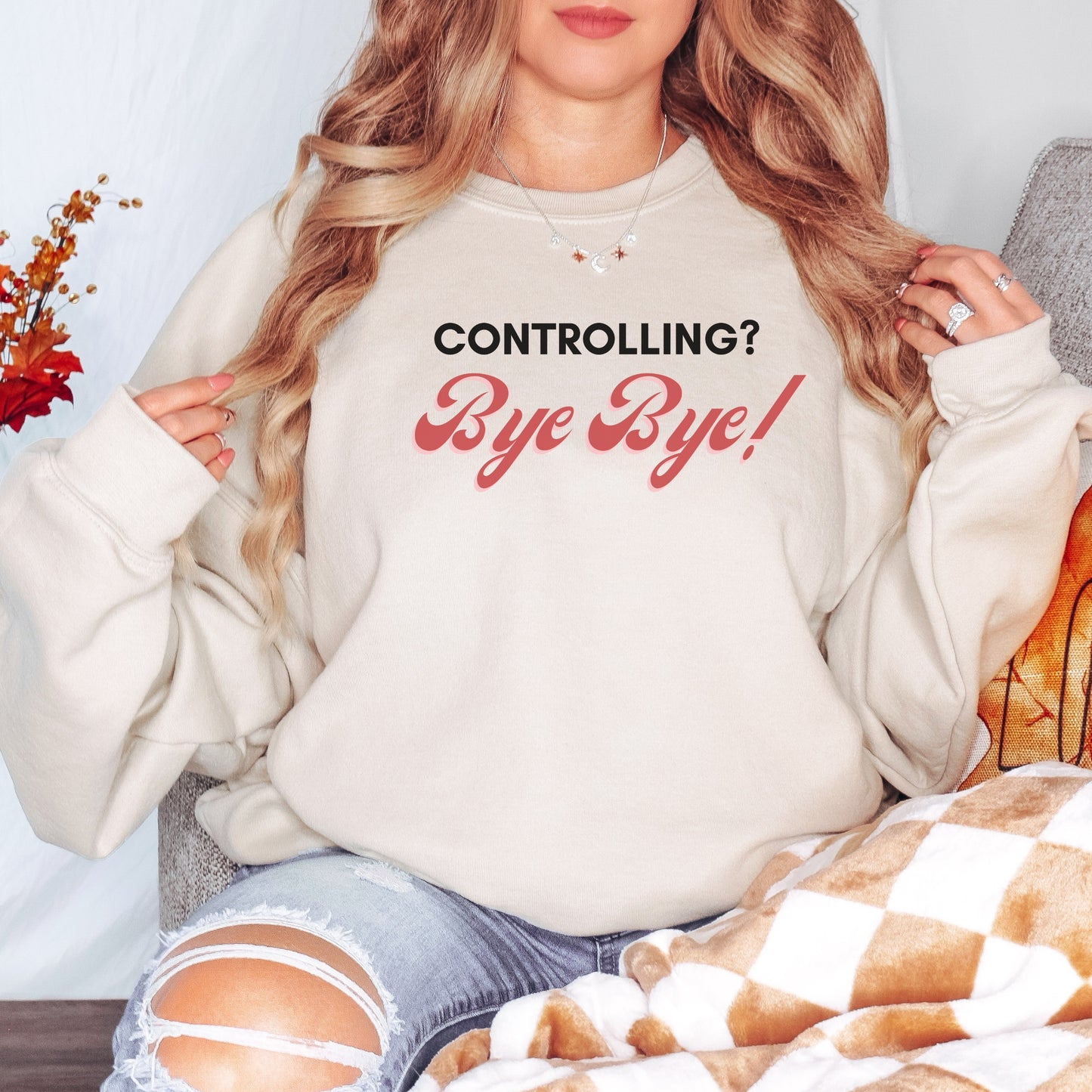 The front of the sweatshirt proudly displays the phrase "Controlling? Bye Bye!" in a bold and eye-catching font. This message serves as a reminder that love is not controlling. Tailored for domestic violence and teen dating violence advocates.