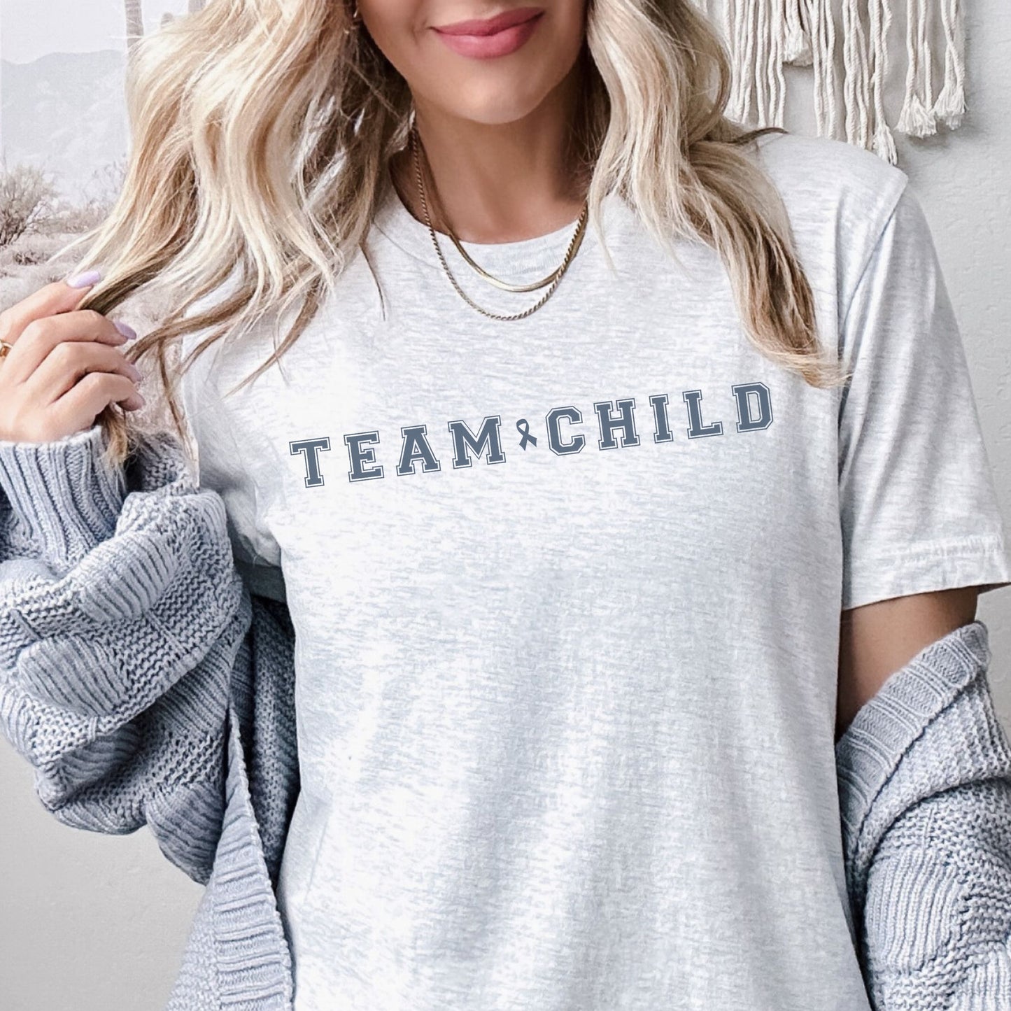 Our exclusive t-shirt has ‘Team Child’ on the front in a bold font with the blue child abuse awareness ribbon between the words. This impactful phrase encapsulates the essence of your commitment to safeguarding children and promoting their well-being. Perfect for child advocates, champions of children’s mental health, and for Child Abuse Awareness and Prevention Month (CAPM)