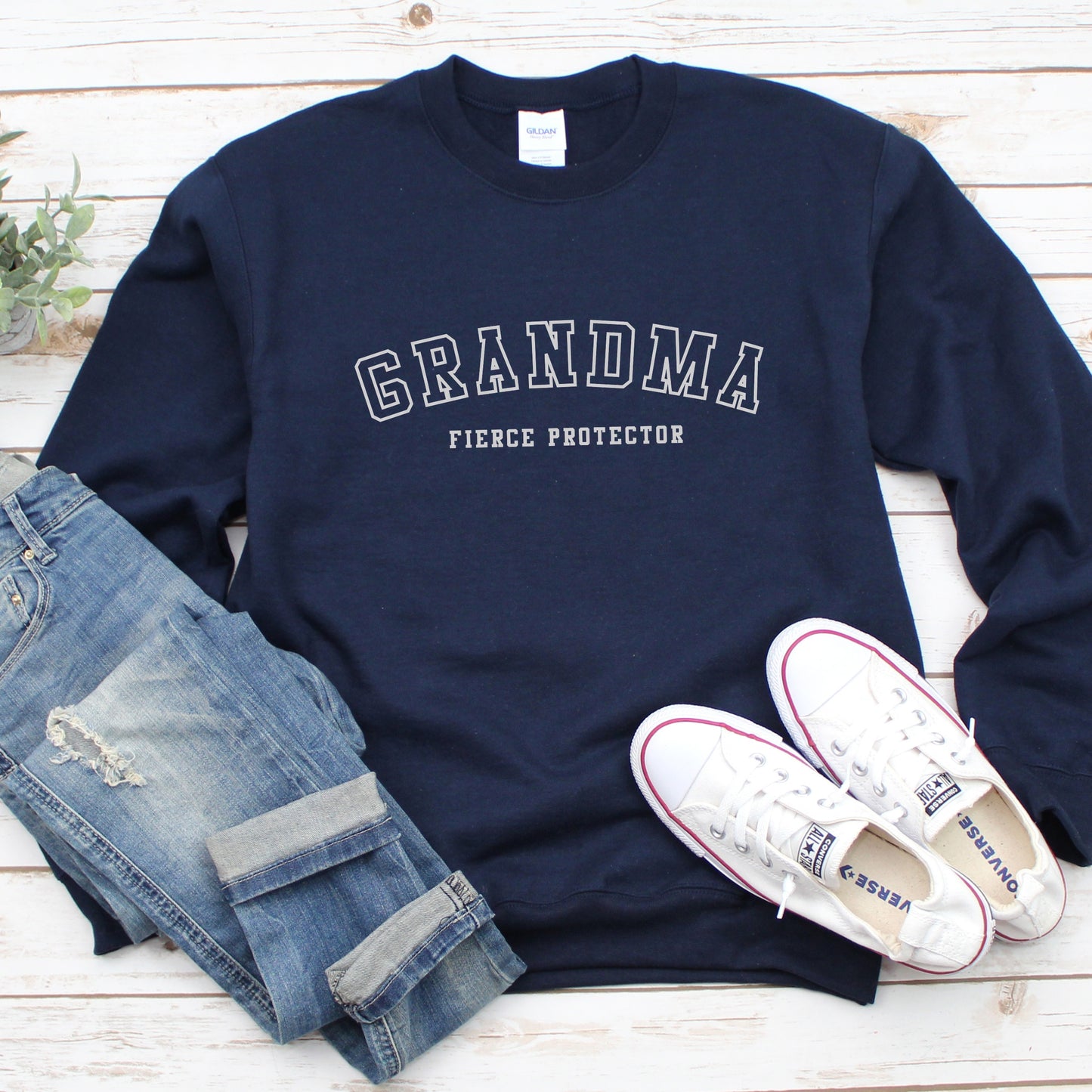 The front of the sweatshirt proudly displays the phrase Grandma Fierce Protector in a bold and eye catching font. This message serves as a reminder that we reject victim blaming and support those who have faced injustice. Your grandma can wear her strength proudly, embracing both comfort and empowerment.