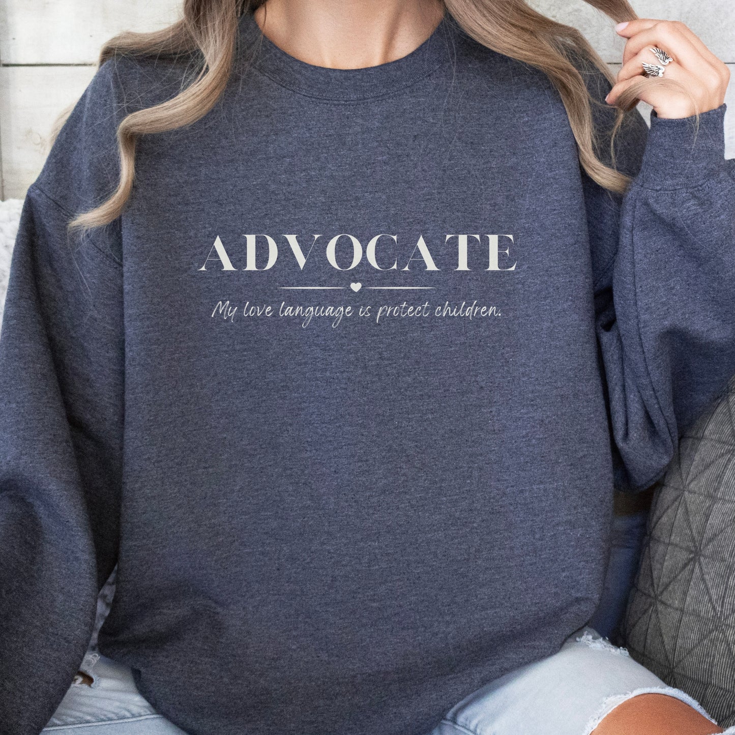 Front and center, the bold message declares, "ADVOCATE: my love language is protect children." This impactful phrase encapsulates the essence of your commitment to safeguarding children and promoting their well-being. Perfect for child advocates, champions of children’s mental health, and for Child Abuse Awareness and Prevention Month