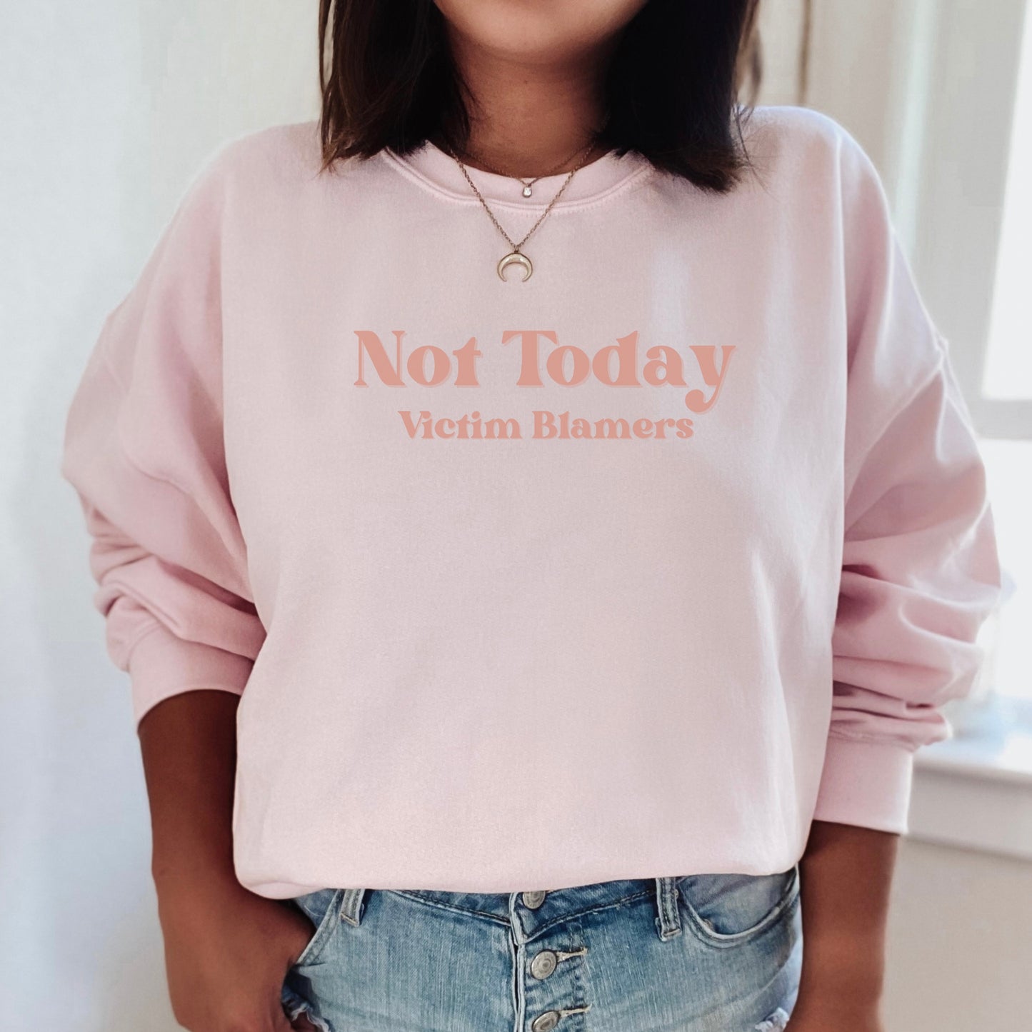 The front of the sweatshirt proudly displays the phrase "Not Today Victim Blamers" in a bold and eye-catching font. This message serves as a reminder that we reject victim-blaming and support those who have faced injustice.