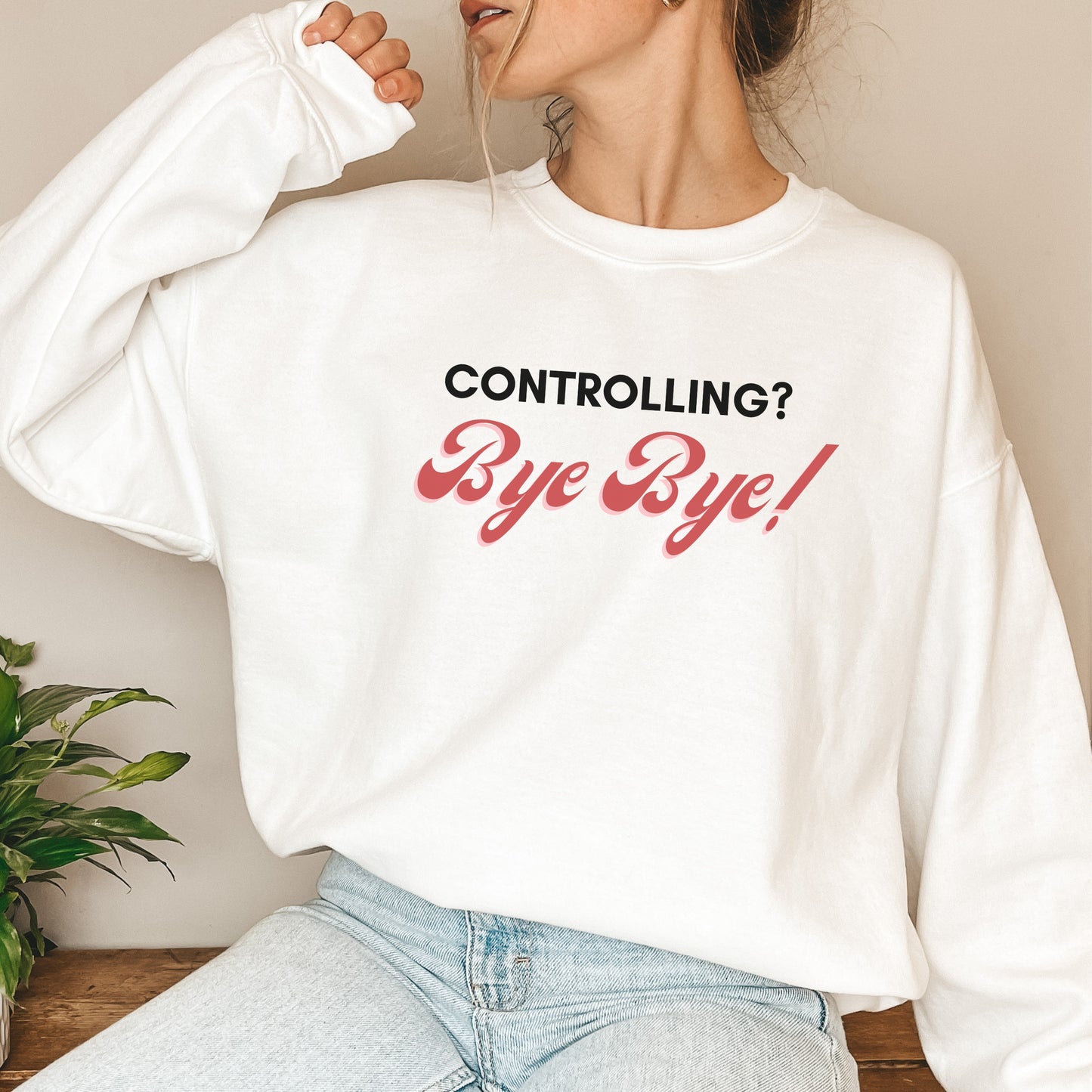 The front of the sweatshirt proudly displays the phrase "Controlling? Bye Bye!" in a bold and eye-catching font. This message serves as a reminder that love is not controlling. Tailored for domestic violence and teen dating violence advocates.