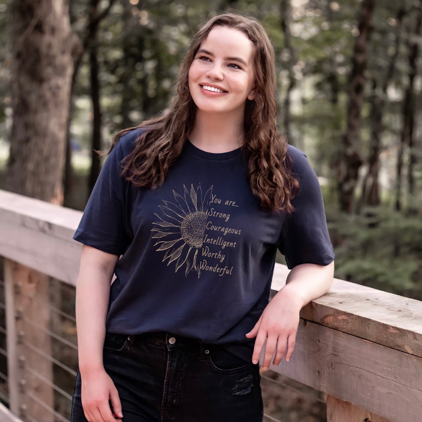 This thoughtfully designed shirt features a vibrant sunflower, symbolizing resilience and growth, accompanied by the powerful mantra: "You are strong, courageous, intelligent, worthy, and wonderful."