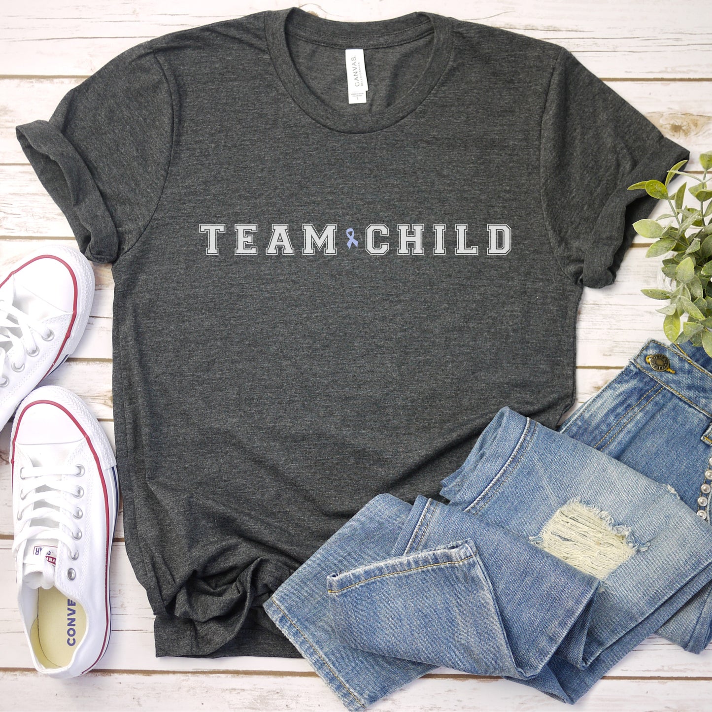 Our exclusive t-shirt has ‘Team Child’ on the front in a bold font with the blue child abuse awareness ribbon between the words. This impactful phrase encapsulates the essence of your commitment to safeguarding children and promoting their well-being. Perfect for child advocates, champions of children’s mental health, and for Child Abuse Awareness and Prevention Month (CAPM)