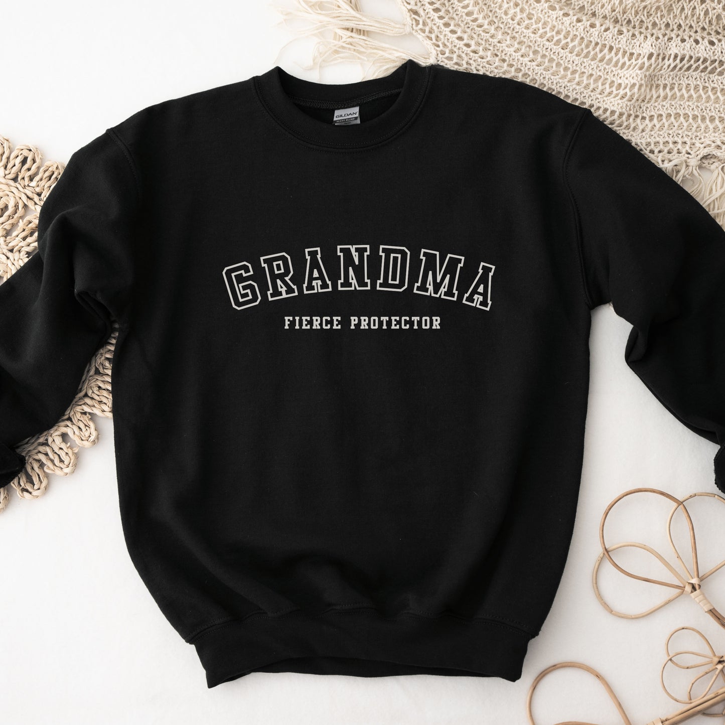 The front of the sweatshirt proudly displays the phrase Grandma Fierce Protector in a bold and eye catching font. This message serves as a reminder that we reject victim blaming and support those who have faced injustice. Your grandma can wear her strength proudly, embracing both comfort and empowerment.