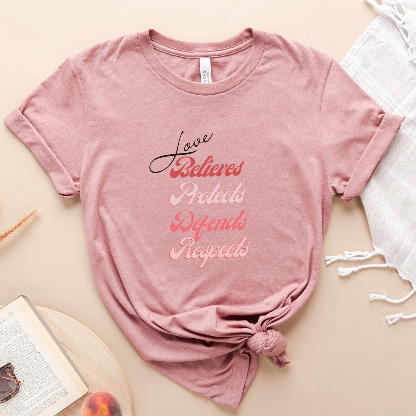 The front of this tshirt has the impactful phrase, "Love Believes Protects Defends Respects," artfully displayed in a beautiful retro font, capturing attention while spreading a message of compassion, strength, and support. Crafted with care and commitment, this tee combines a powerful message with a touch of retro elegance.