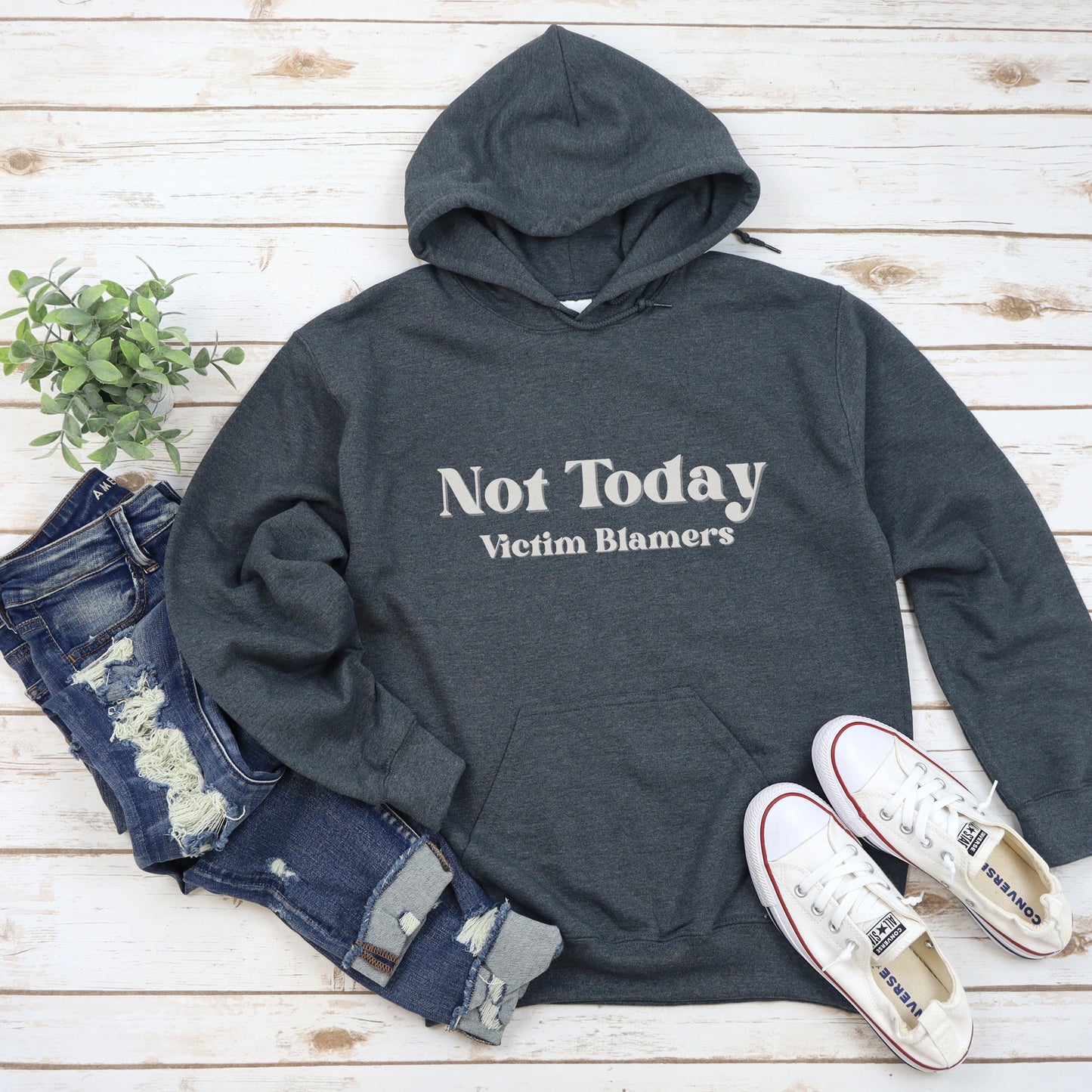 The front of the hooded sweatshirt proudly displays the phrase Not Today Victim Blamers in a bold and eye catching font. This message serves as a reminder that we reject victim blaming and support those who have faced injustice.