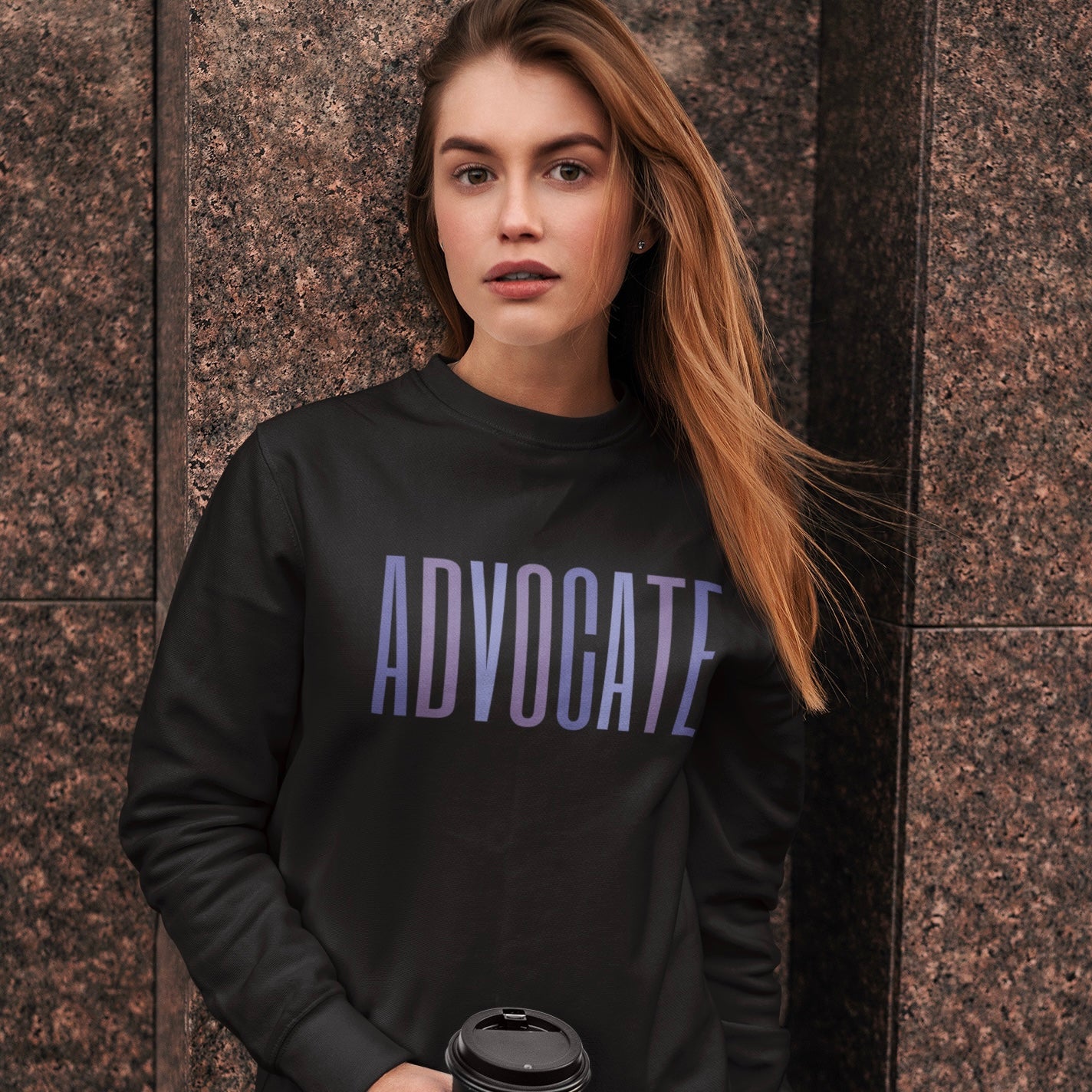 Crewneck sweatshirt with a powerful "ADVOCATE" wordmark emblazoned across the chest in varying shades of purple, symbolizing the strength and unity of domestic violence advocates. The gradient effect from deep violet to lavender adds an eye-catching touch, making this sweater a visually compelling tribute to your commitment to ending domestic abuse.