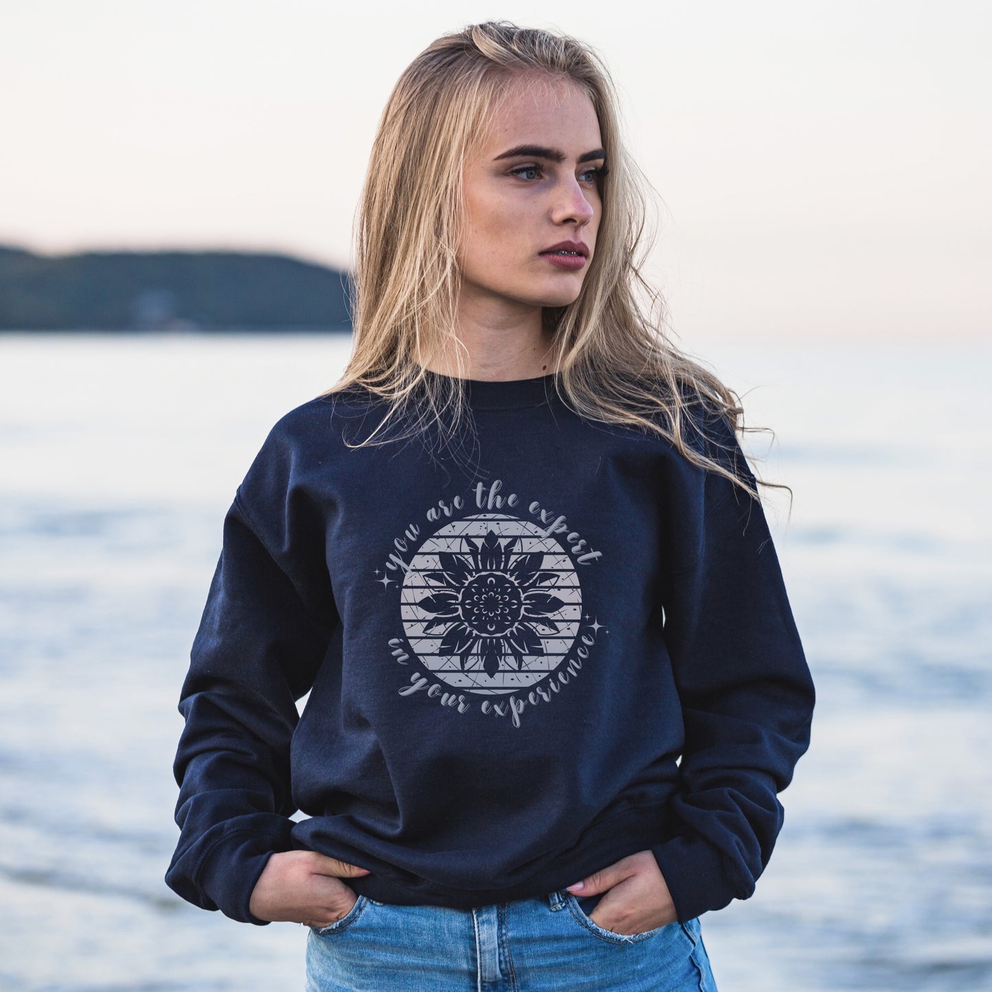 Mental health empowerment with our unique sweatshirt, tailored for survivors and advocates of abuse and trauma. The boho sunflower, a symbol of strength and growth, is surrounded by the powerful message, You are the expert in your experience.
