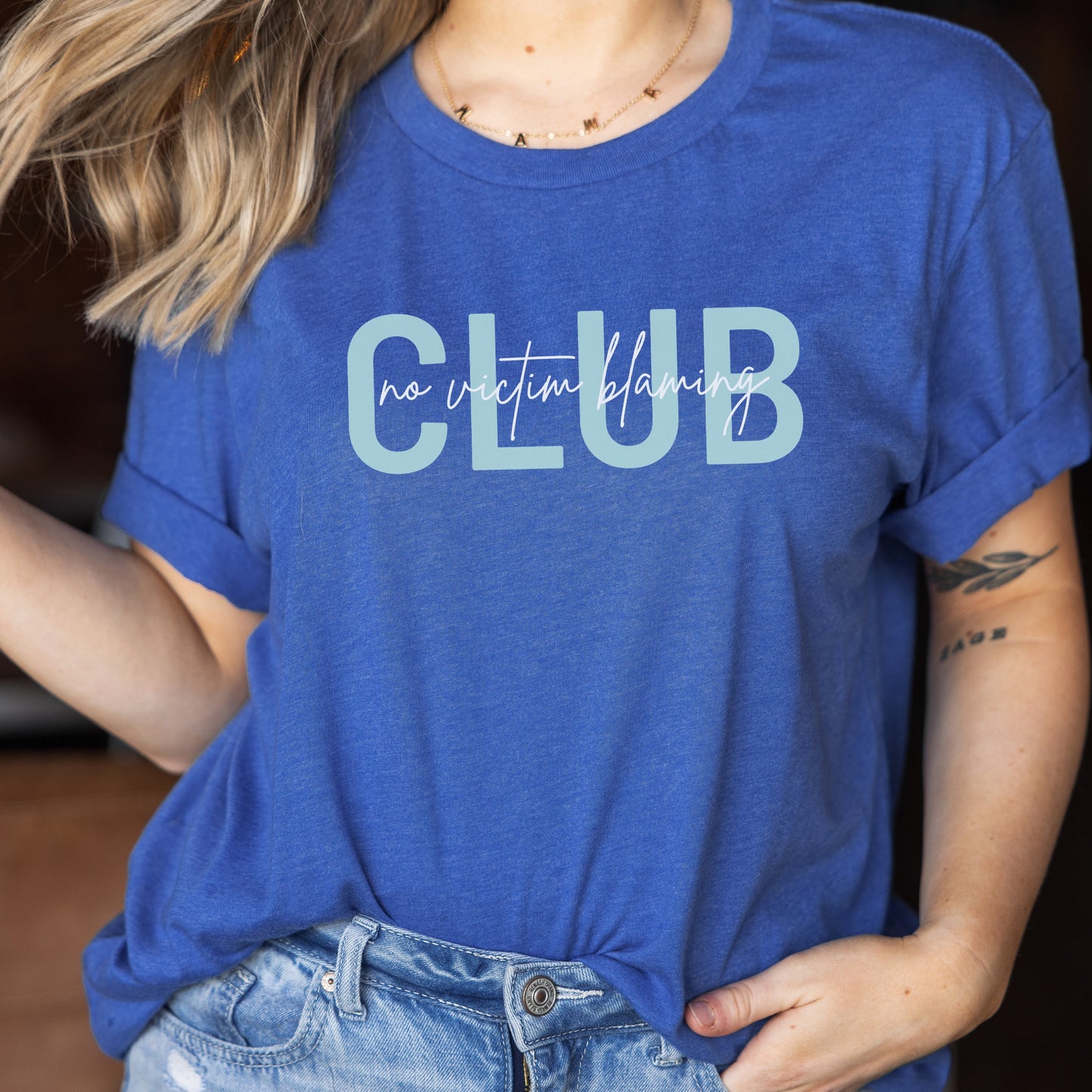 Club is on the front in bold teal letters with the phrase “No Victim Blaming” written over it in black or white. The back has a SAAM teal awareness ribbon with the words “We Are With You #SAAM” with a teal heart. Be a walking ambassador for awareness and change. Perfect For Sexual Assault Awareness Month and Denim Day.