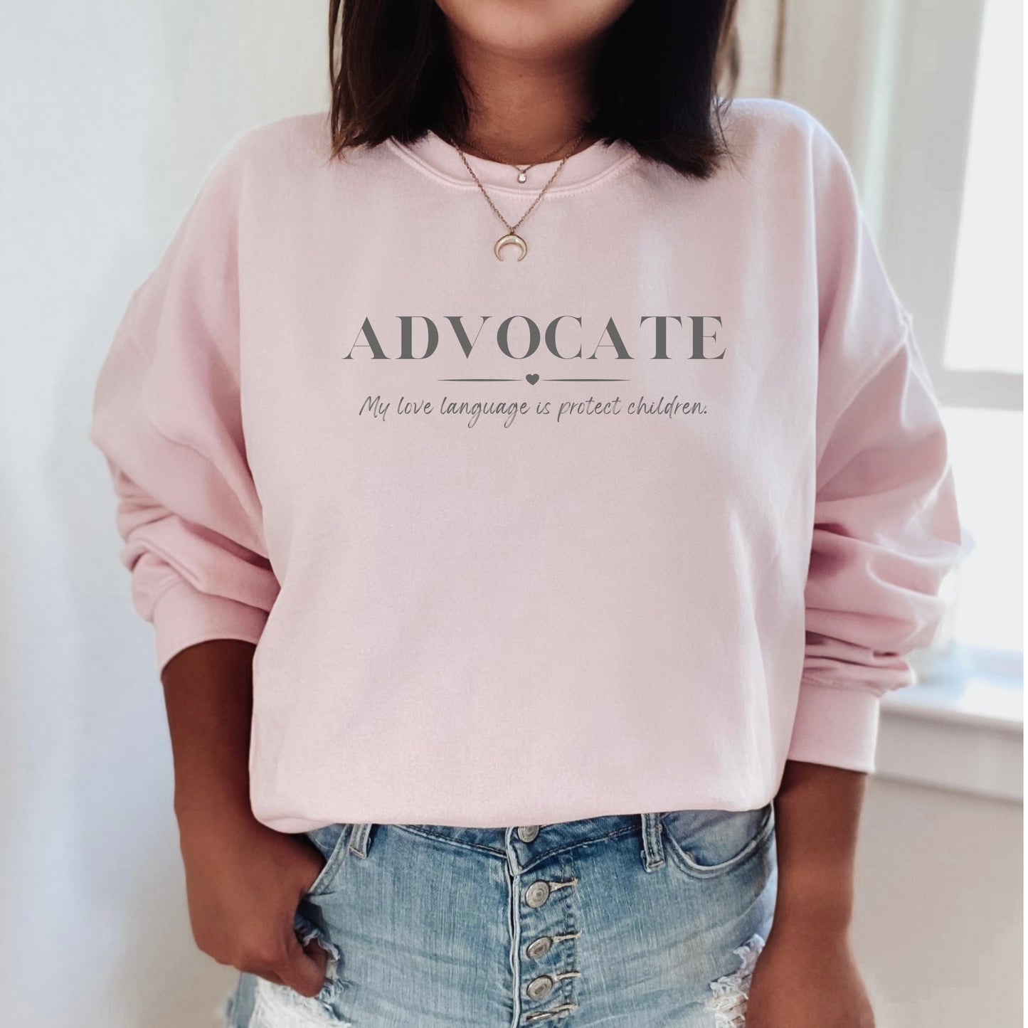 Front and center, the bold message declares, "ADVOCATE: my love language is protect children." This impactful phrase encapsulates the essence of your commitment to safeguarding children and promoting their well-being. Perfect for child advocates, champions of children’s mental health, and for Child Abuse Awareness and Prevention Month