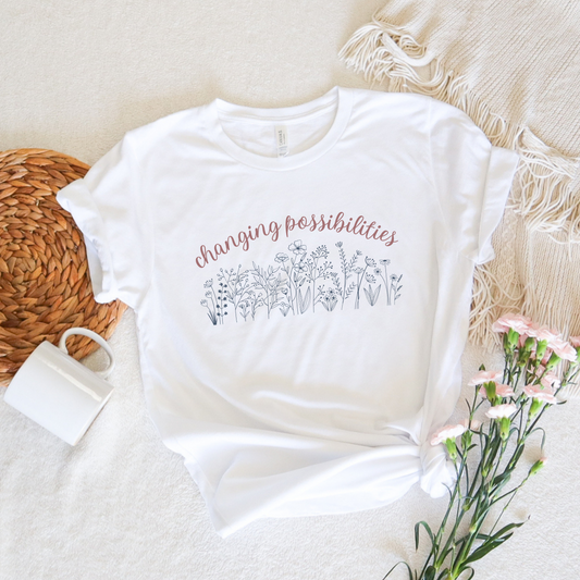 The front of this tshirt has the empowering words Changing Possibilities over a beautiful wildflower design. This tee celebrates advocates who are changing the world. Join the movement to change possibilities and create a culture of empowerment.
