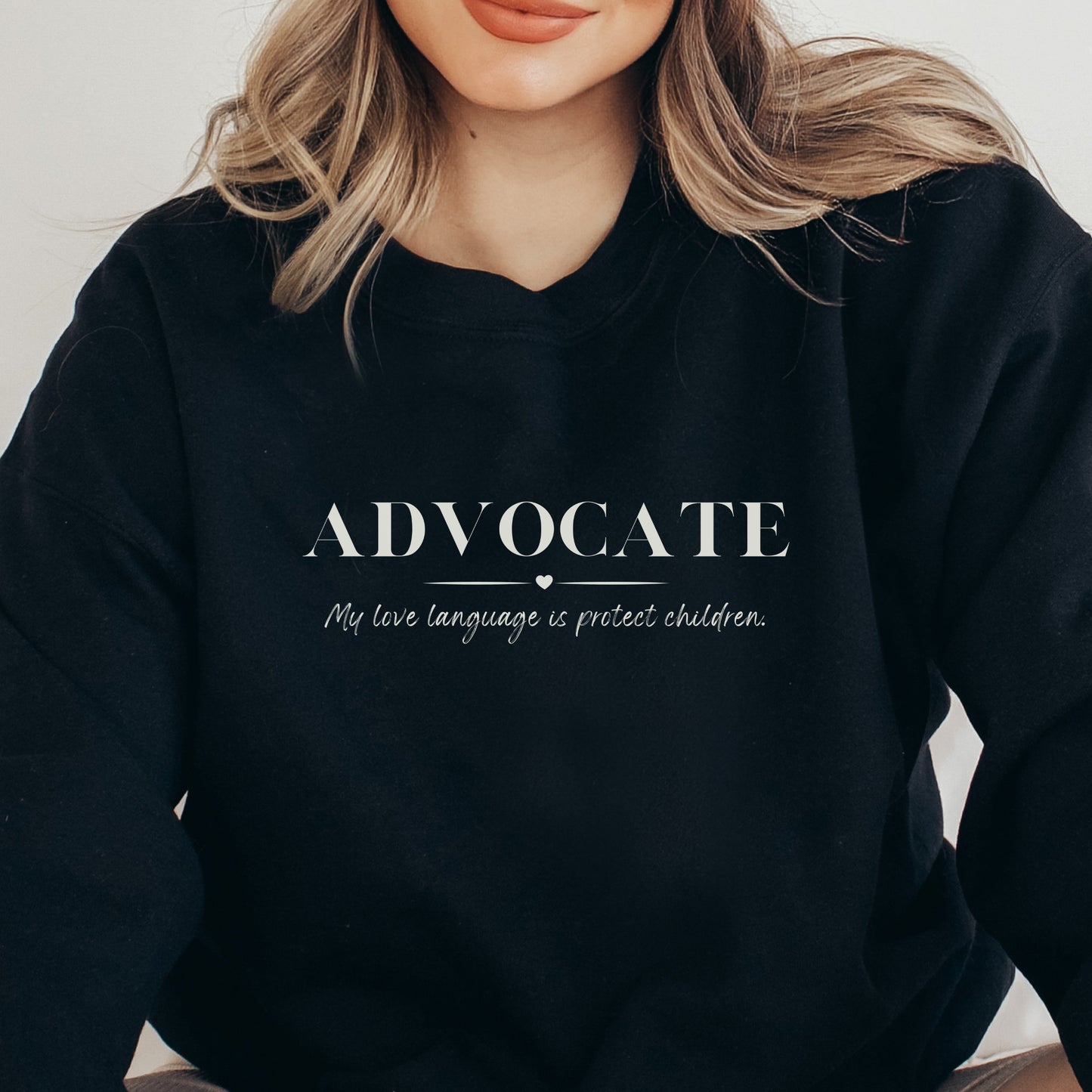 Front and center, the bold message declares, "ADVOCATE: my love language is protect children." This impactful phrase encapsulates the essence of your commitment to safeguarding children and promoting their well-being. Perfect for child advocates, champions of children’s mental health, and for Child Abuse Awareness and Prevention Month