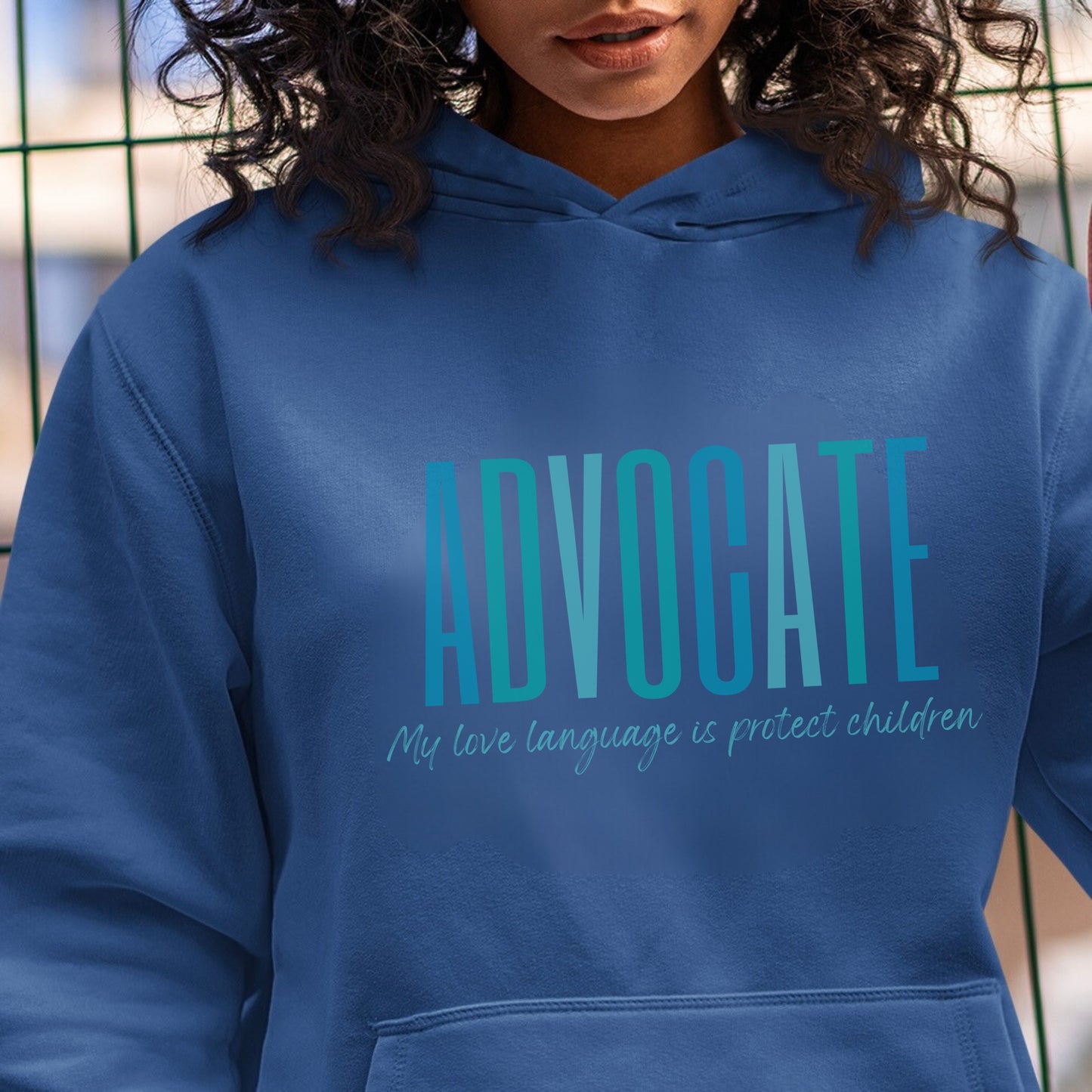 Front and center of this hooded sweatshirt, the bold message declares, "ADVOCATE: my love language is protect children." Artfully designed in varying shades of blue, this impactful phrase encapsulates the essence of your commitment to safeguarding children and promoting their well-being. Perfect for child advocates, champions of children’s mental health, and for Child Abuse Awareness and Prevention Month