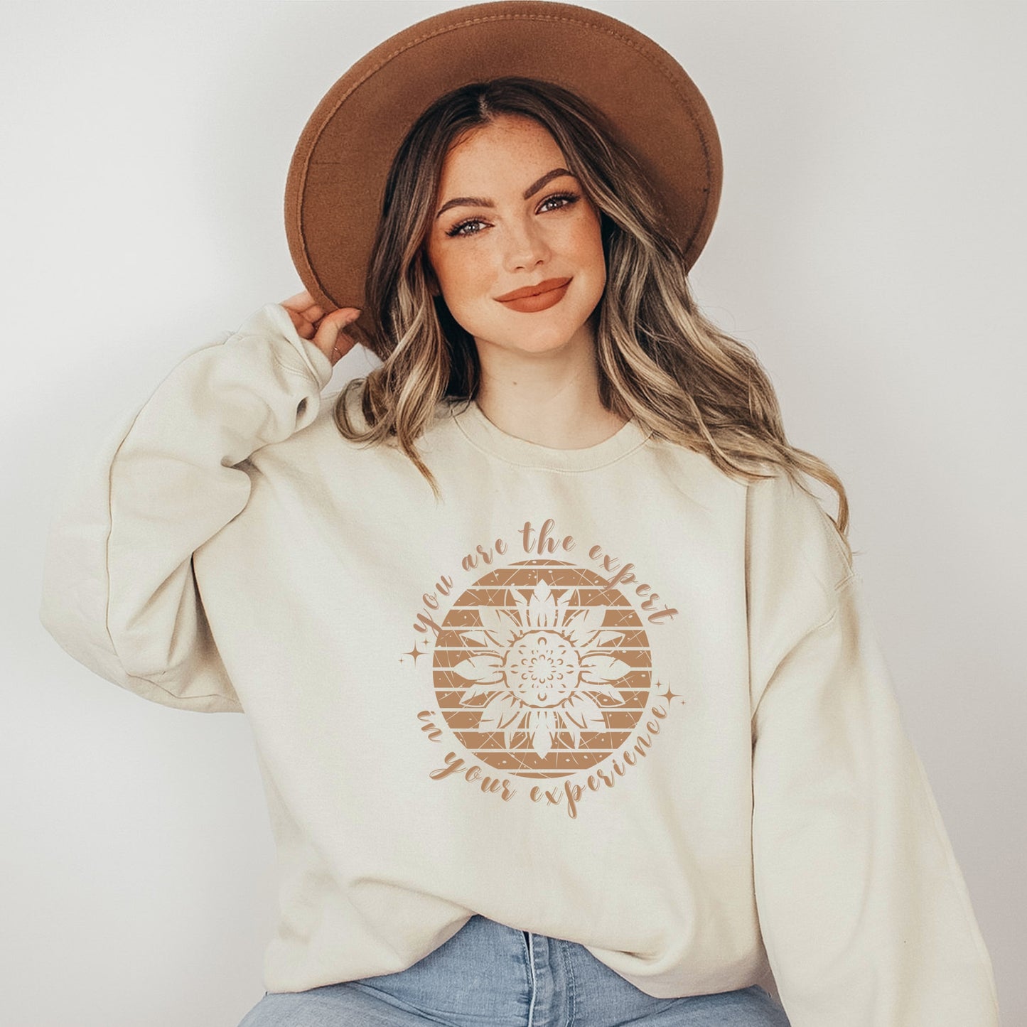 Mental health empowerment with our unique sweatshirt, tailored for survivors and advocates of abuse and trauma. The boho sunflower, a symbol of strength and growth, is surrounded by the powerful message, You are the expert in your experience.