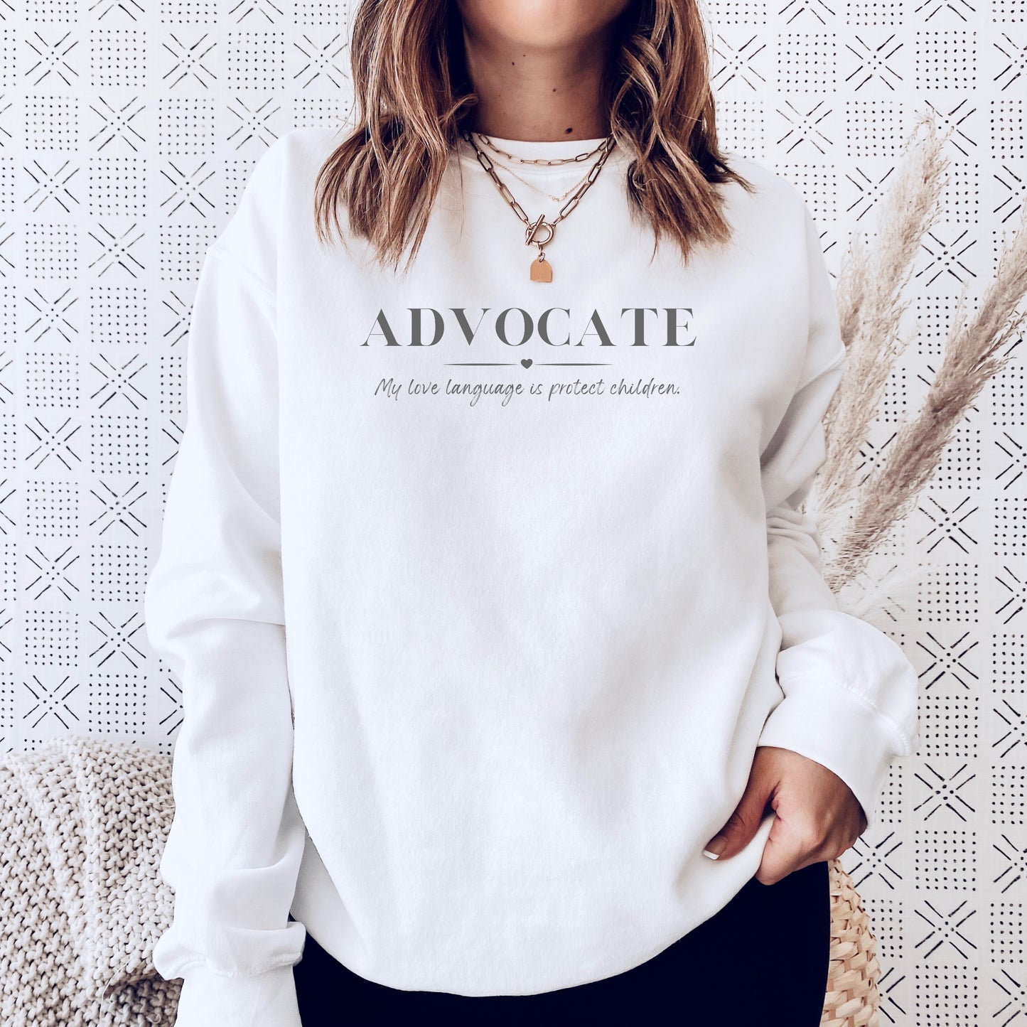 Front and center, the bold message declares, "ADVOCATE: my love language is protect children." This impactful phrase encapsulates the essence of your commitment to safeguarding children and promoting their well-being. Perfect for child advocates, champions of children’s mental health, and for Child Abuse Awareness and Prevention Month