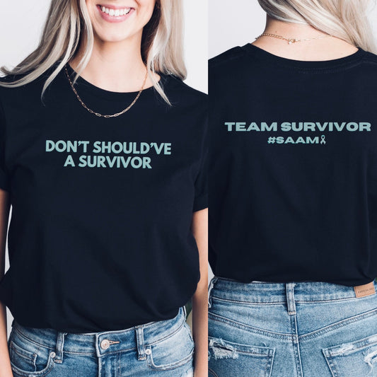 The front of the T-shirt has the empowering saying ‘Don’t Should’ve A Survivor’ and the back says Team Survivor SAAM with the teal awareness ribbon. Designed to support survivors and end victim blaming during April Sexual Assault Awareness Month (SAAM) and Denim Day. Perfect for survivors, child and victim advocates, and mental health advocates.