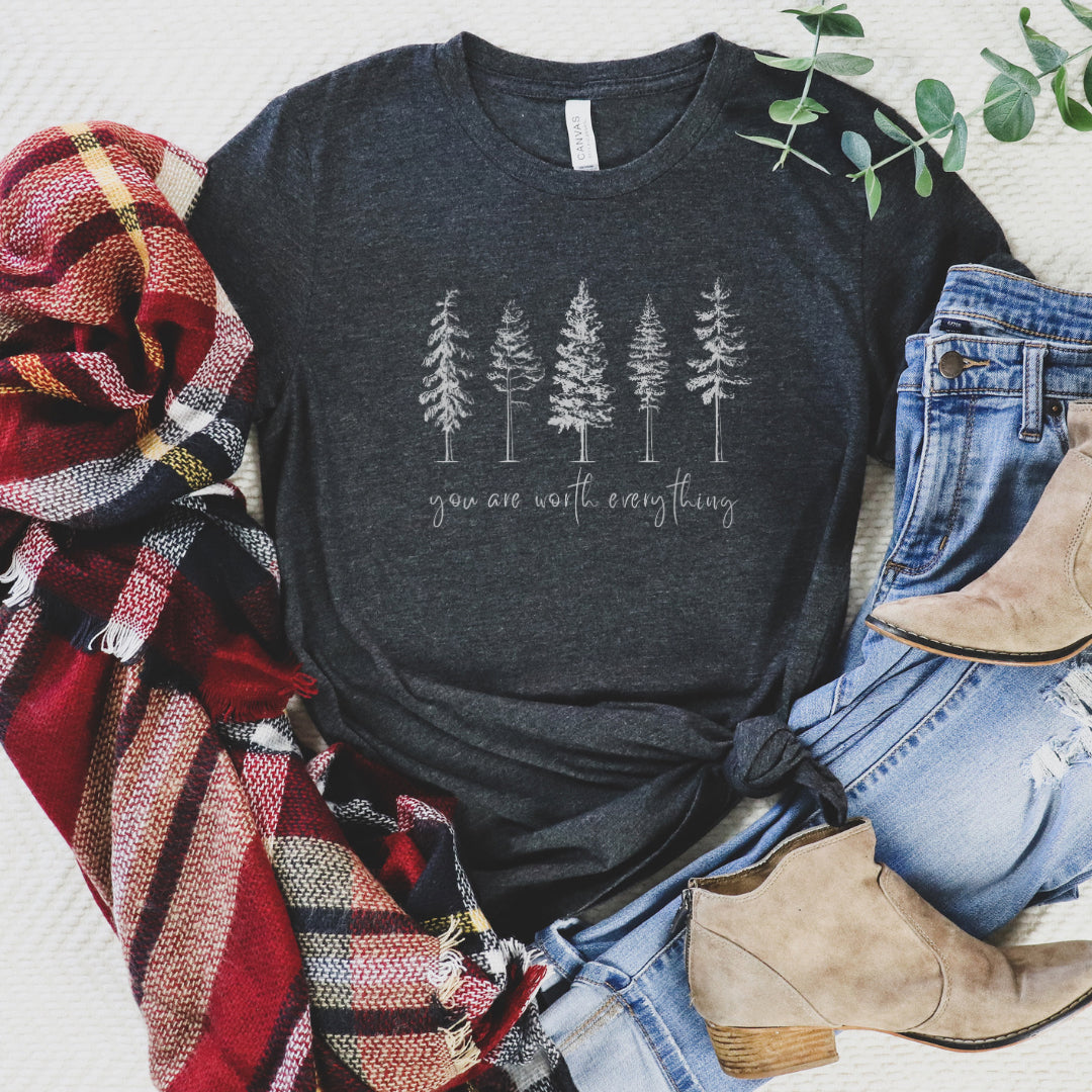 Adorned with beautiful enchanting winter pine trees graphic and the empowering affirmation message You Are Worth Everything, this Tshirt is a wearable reminder of your inherent value worth and uniqueness. Perfect gift for mom, advocate, social worker