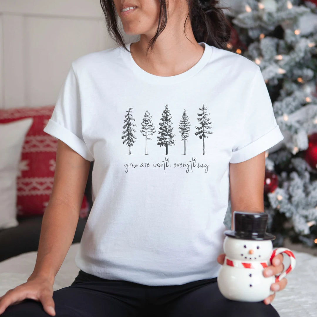 Adorned with beautiful enchanting winter pine trees graphic and the empowering affirmation message You Are Worth Everything, this Tshirt is a wearable reminder of your inherent value worth and uniqueness. Perfect gift for mom, advocate, social worker