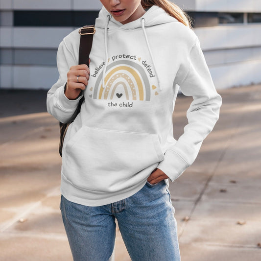 The front of the sweatshirt proudly displays a boho rainbow with the phrase "Believe Protect Defend The Child” in a whimsical and eye-catching font. A powerful message that underscores the importance of safeguarding children's rights and well-being.