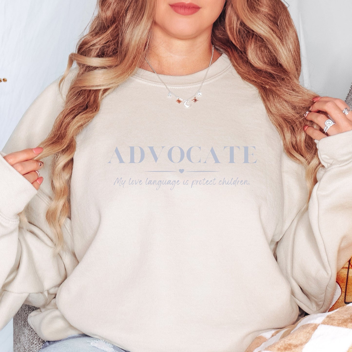 Front and center, the bold message declares, "ADVOCATE: my love language is protect children." This impactful phrase encapsulates the essence of your commitment to safeguarding children and promoting their well-being. Perfect for child advocates, champions of children’s mental health, and for Child Abuse Awareness and Prevention Month