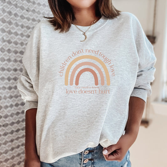 The front of the sweatshirt boldly declares, "Children don't need tough love, they need to know love doesn't hurt." It serves as a rallying cry for advocates, emphasizing the importance of fostering environments where love is synonymous with safety and support.