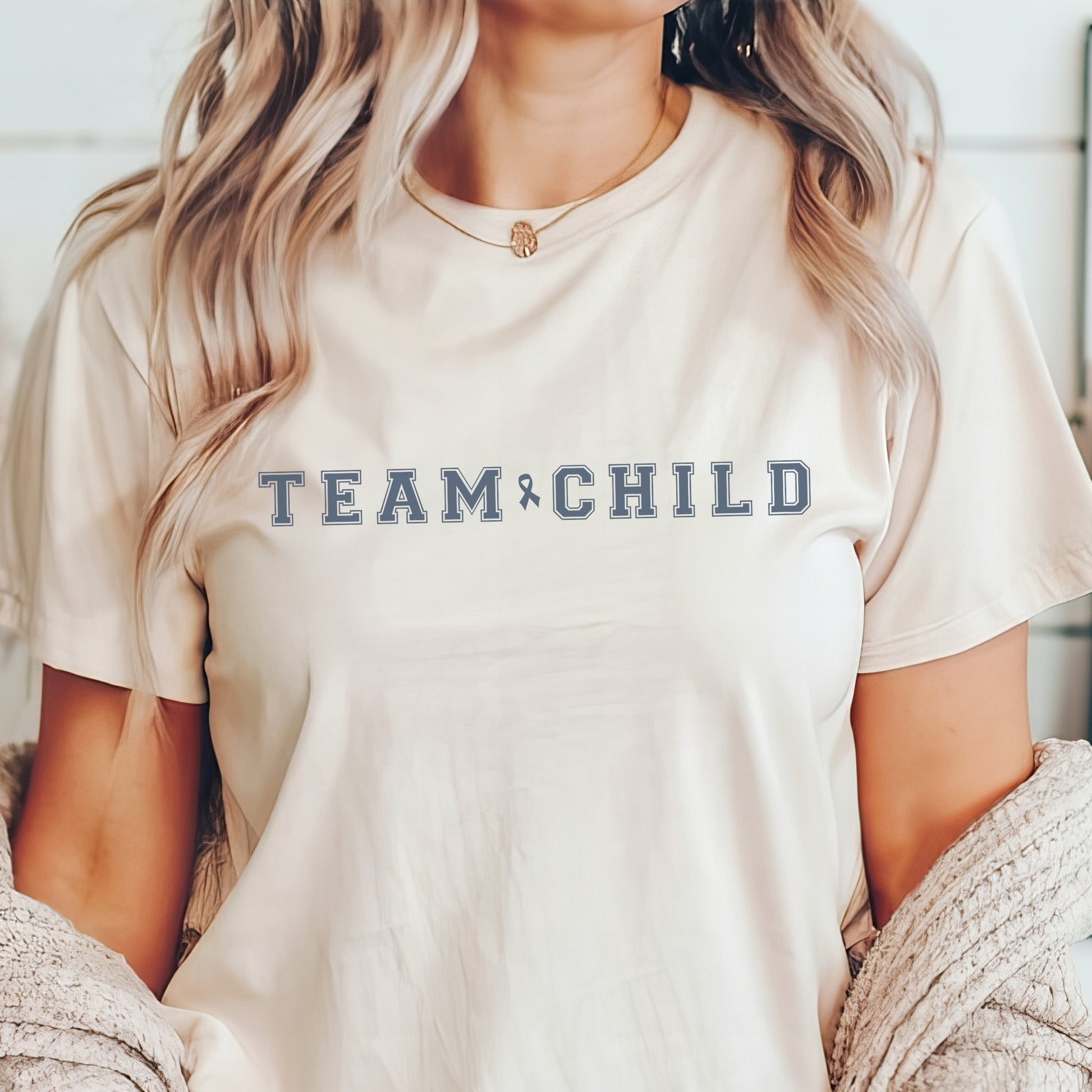 Our exclusive t-shirt has ‘Team Child’ on the front in a bold font with the blue child abuse awareness ribbon between the words. This impactful phrase encapsulates the essence of your commitment to safeguarding children and promoting their well-being. Perfect for child advocates, champions of children’s mental health, and for Child Abuse Awareness and Prevention Month (CAPM)