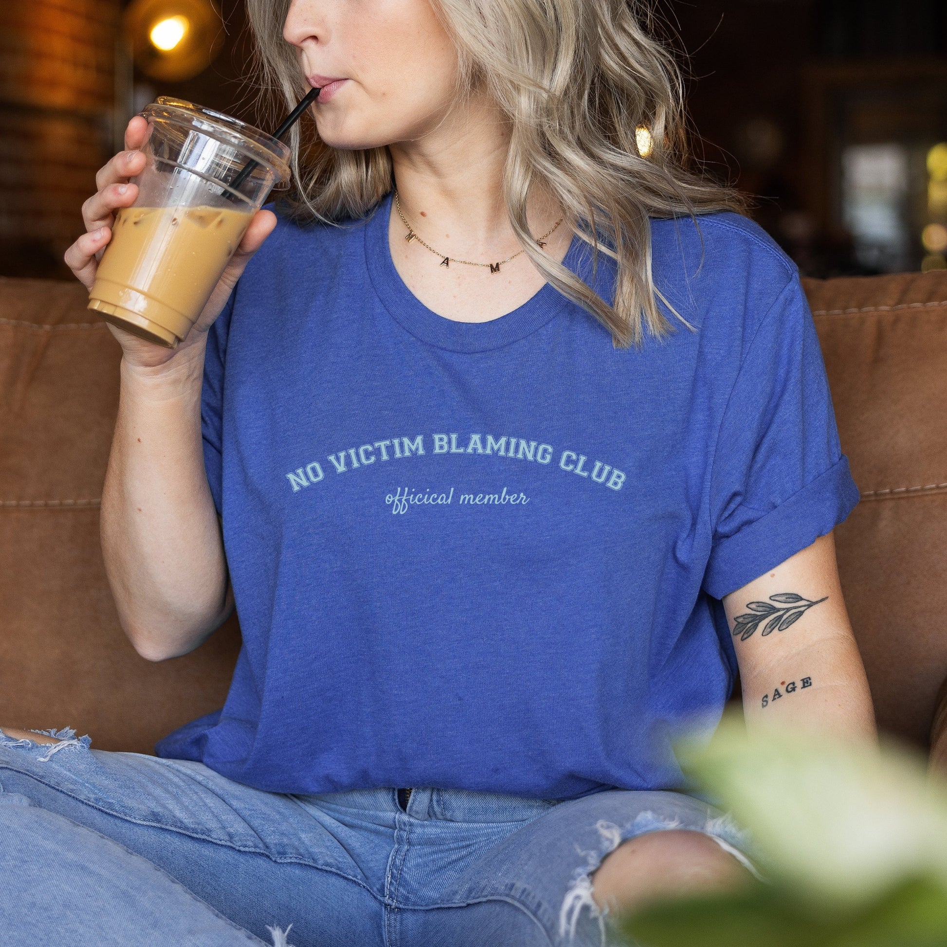 The front of the T-shirt has the empowering saying in teal, ‘No Victim Blaming Club Official Member’, and the back says ‘Why I Wear Denim #SAAM’. Designed to support survivors and end victim blaming during April’s Sexual Assault Awareness Month and Denim Day.