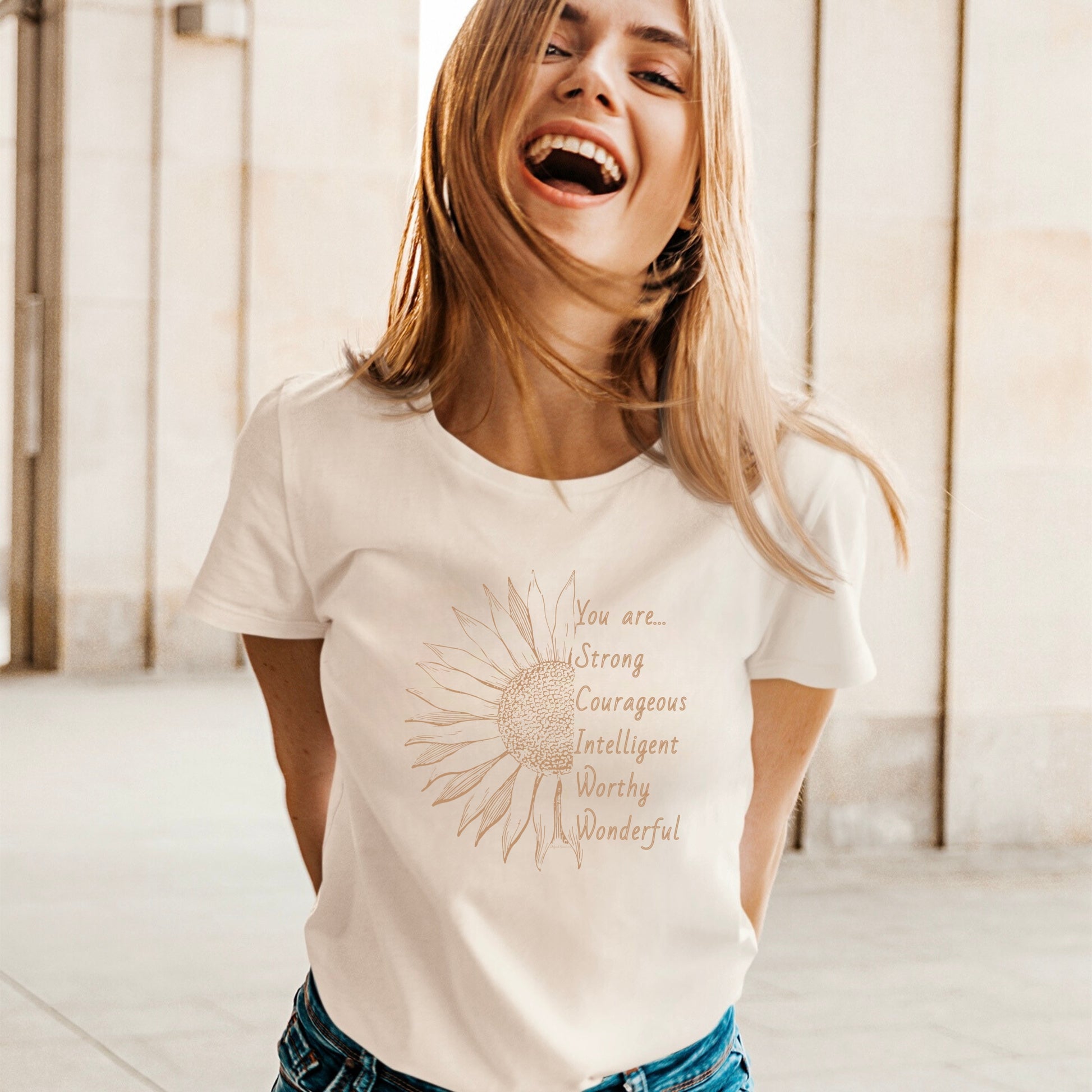 This thoughtfully designed shirt features a vibrant sunflower, symbolizing resilience and growth, accompanied by the powerful mantra: "You are strong, courageous, intelligent, worthy, and wonderful."