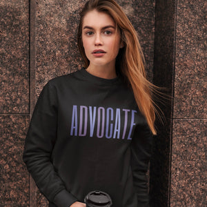 Black crewneck sweatshirt with a powerful  "ADVOCATE" wordmark emblazoned across the chest in varying shades of purple, symbolizing the strength and unity of domestic violence advocates. The gradient effect from deep violet to lavender adds an eye-catching touch, making this sweater a visually compelling tribute to your commitment to ending domestic abuse.
