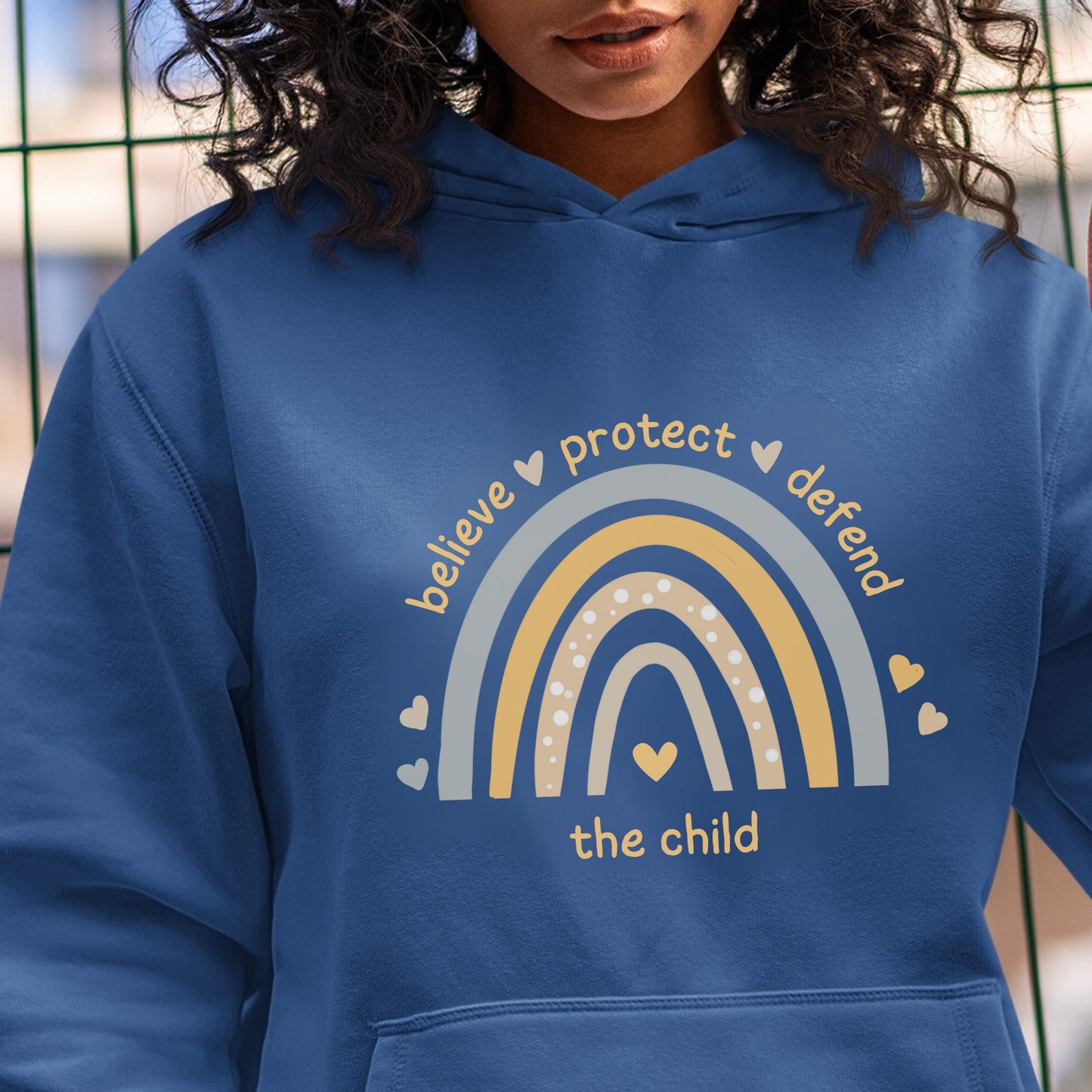  The front of the sweatshirt proudly displays a boho rainbow with the phrase "Believe Protect Defend The Child” in a whimsical and eye-catching font. A powerful message that underscores the importance of safeguarding children's rights and well-being.