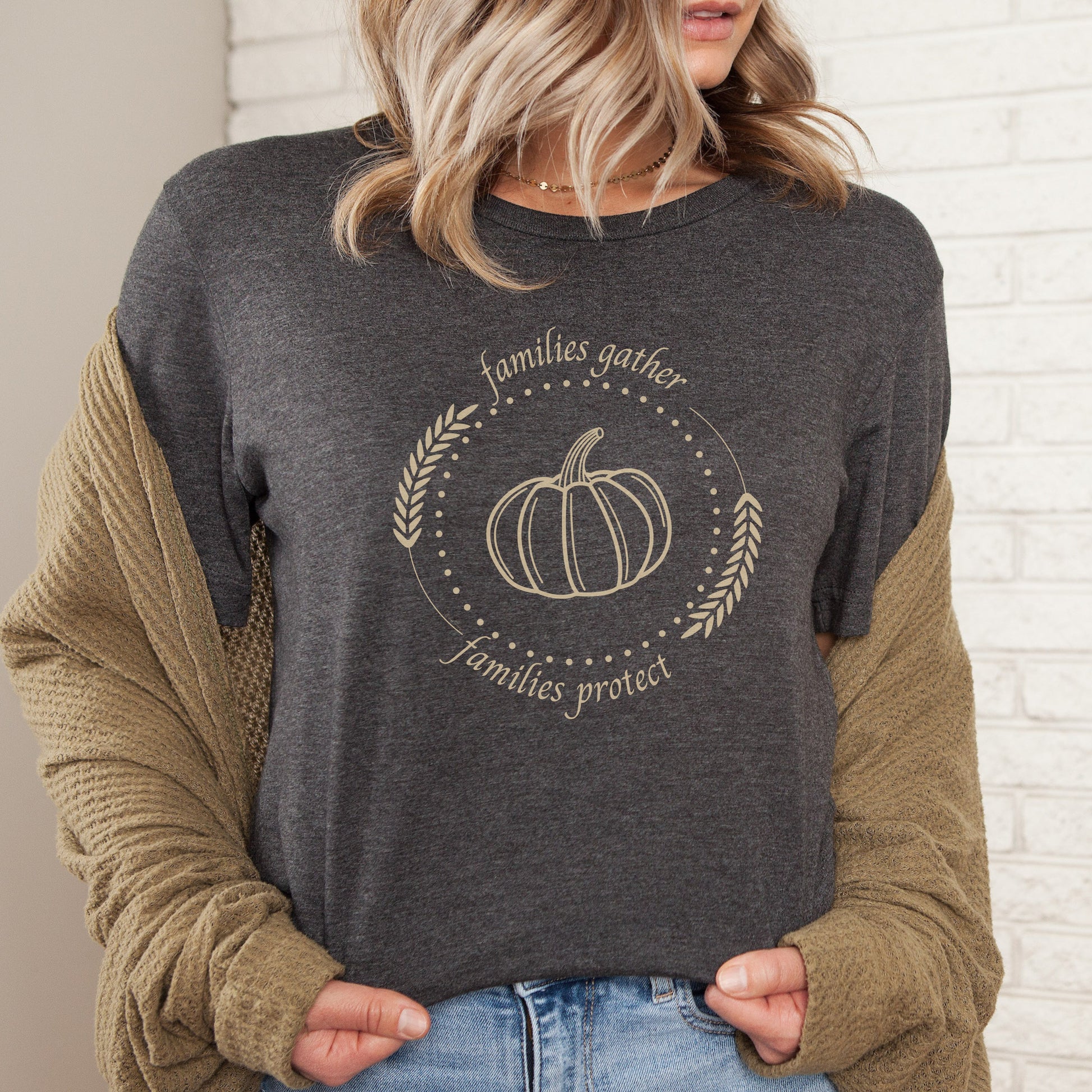 Adorned with a heartwarming autumn-fall harvest pumpkin graphic and the inspiring message Families Gather, Families Protect, this White T-shirt stands as a testament to the unwavering support and protection families should offer to survivors.