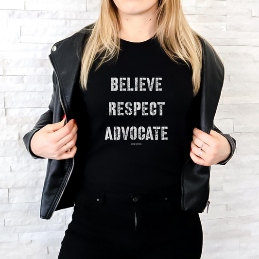  The front of this tshirt has the empowering words Believe Respect Advocate in a bold distressed font. Created for survivors of trauma and abuse, as well as mental health advocates who believe in fostering respect and supporting survivors