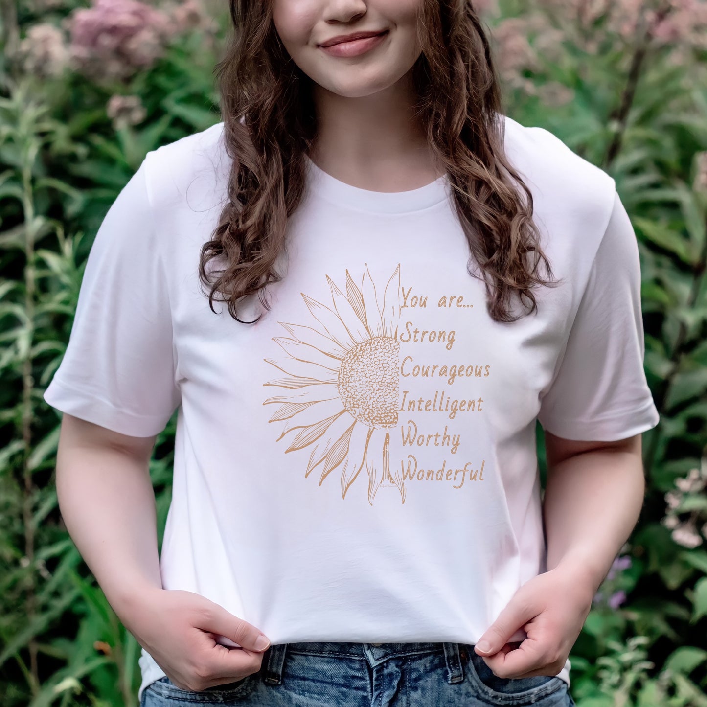 This thoughtfully designed shirt features a vibrant sunflower, symbolizing resilience and growth, accompanied by the powerful mantra: "You are strong, courageous, intelligent, worthy, and wonderful."