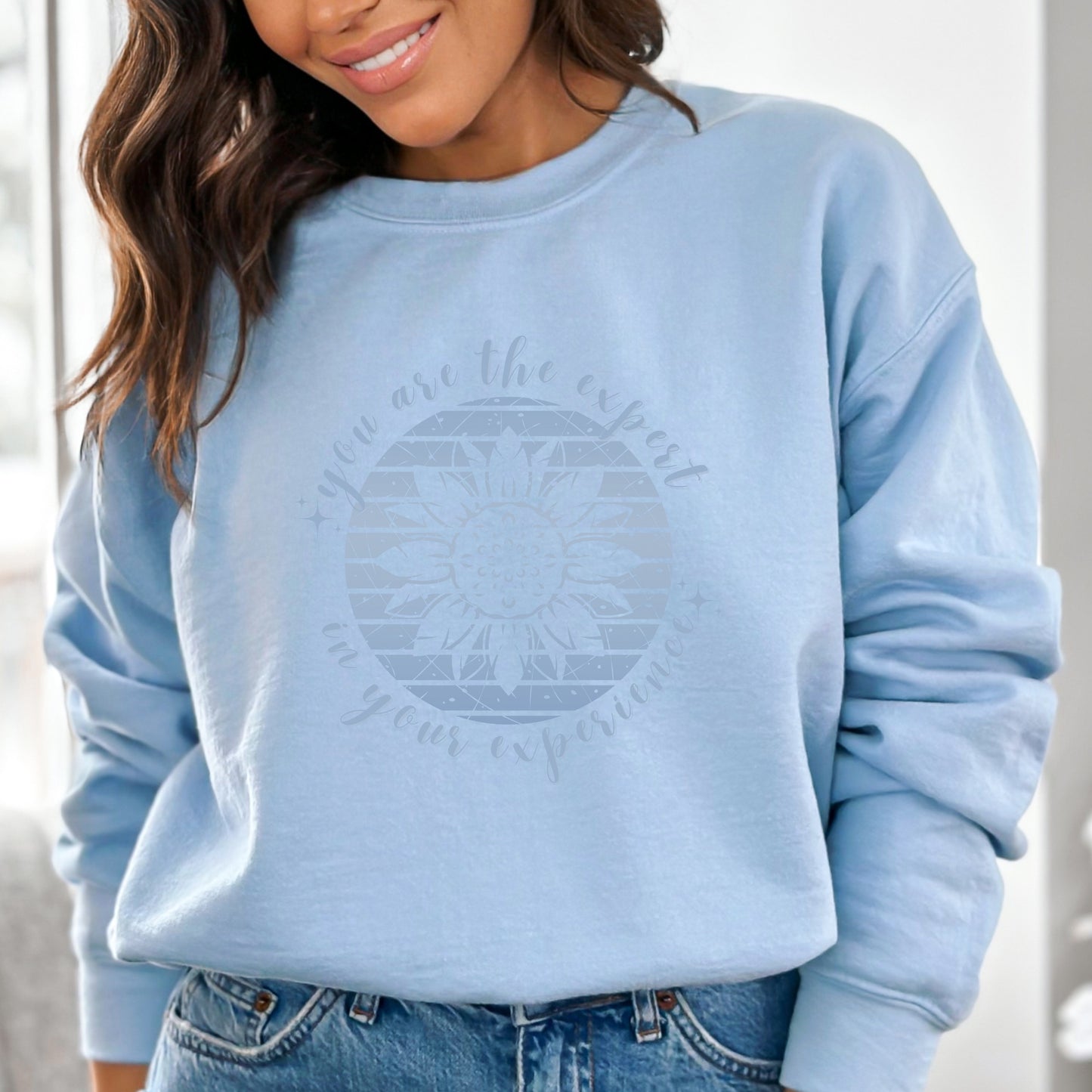 Mental health empowerment with our unique sweatshirt, tailored for survivors and advocates of abuse and trauma. The boho sunflower, a symbol of strength and growth, is surrounded by the powerful message, You are the expert in your experience.