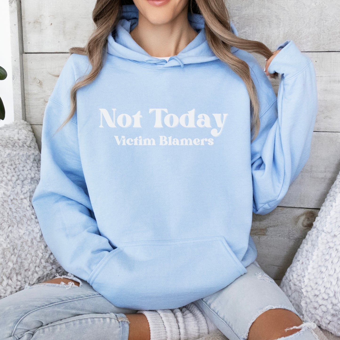 The front of the hooded sweatshirt proudly displays the phrase Not Today Victim Blamers in a bold and eye catching font. This message serves as a reminder that we reject victim blaming and support those who have faced injustice.