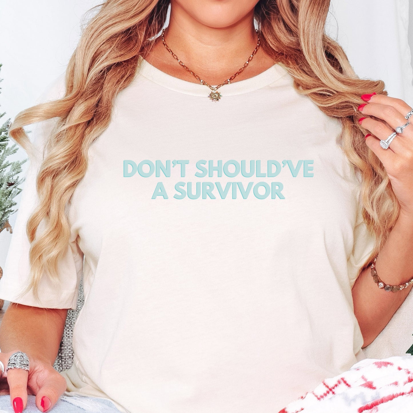 The front of the T-shirt has the empowering saying ‘Don’t Should’ve A Survivor’ and the back says Team Survivor SAAM with the teal awareness ribbon. Designed to support survivors and end victim blaming during April Sexual Assault Awareness Month (SAAM) and Denim Day. Perfect for survivors, child and victim advocates, and mental health advocates.