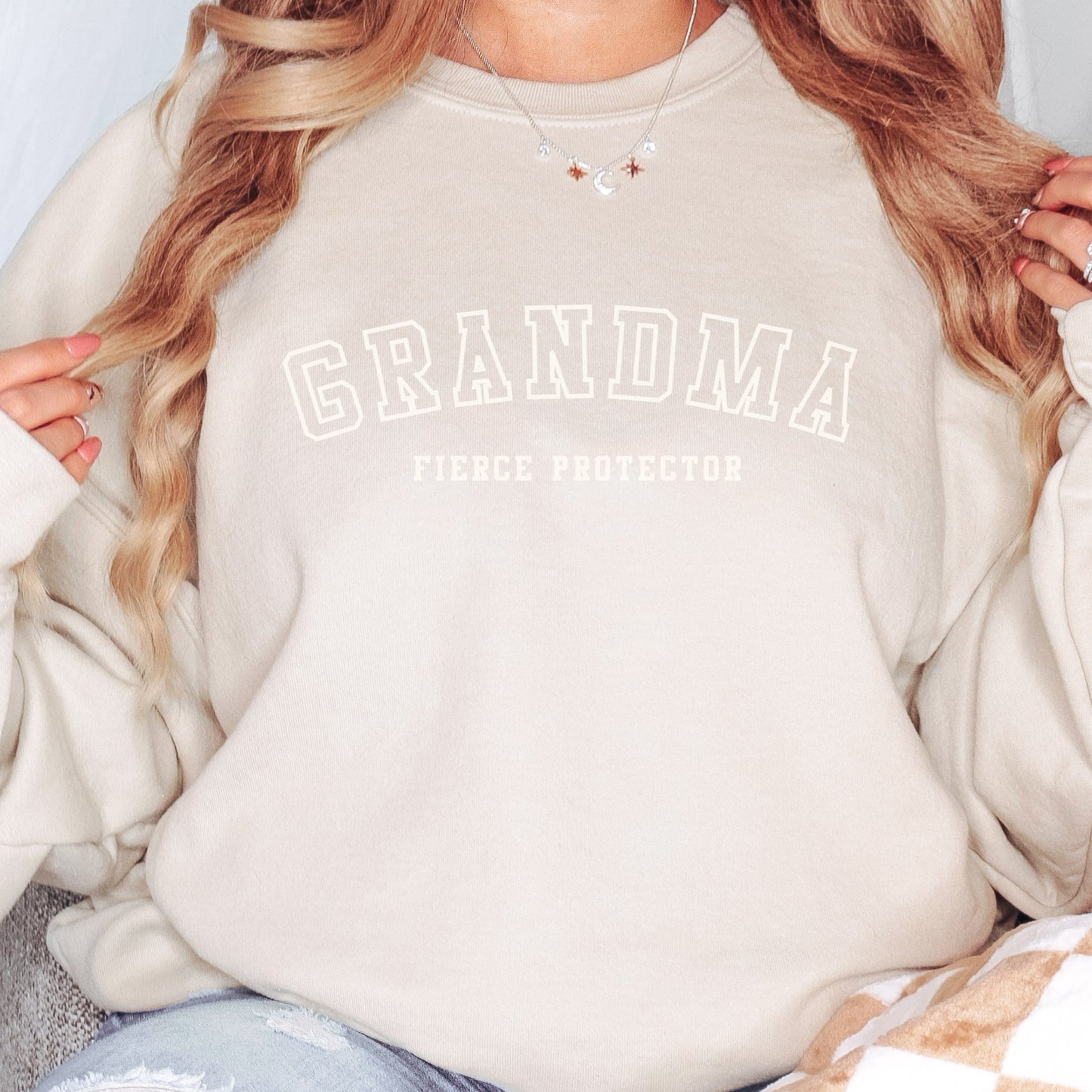 The front of the sweatshirt proudly displays the phrase Grandma Fierce Protector in a bold and eye catching font. This message serves as a reminder that we reject victim blaming and support those who have faced injustice. Your grandma can wear her strength proudly, embracing both comfort and empowerment.