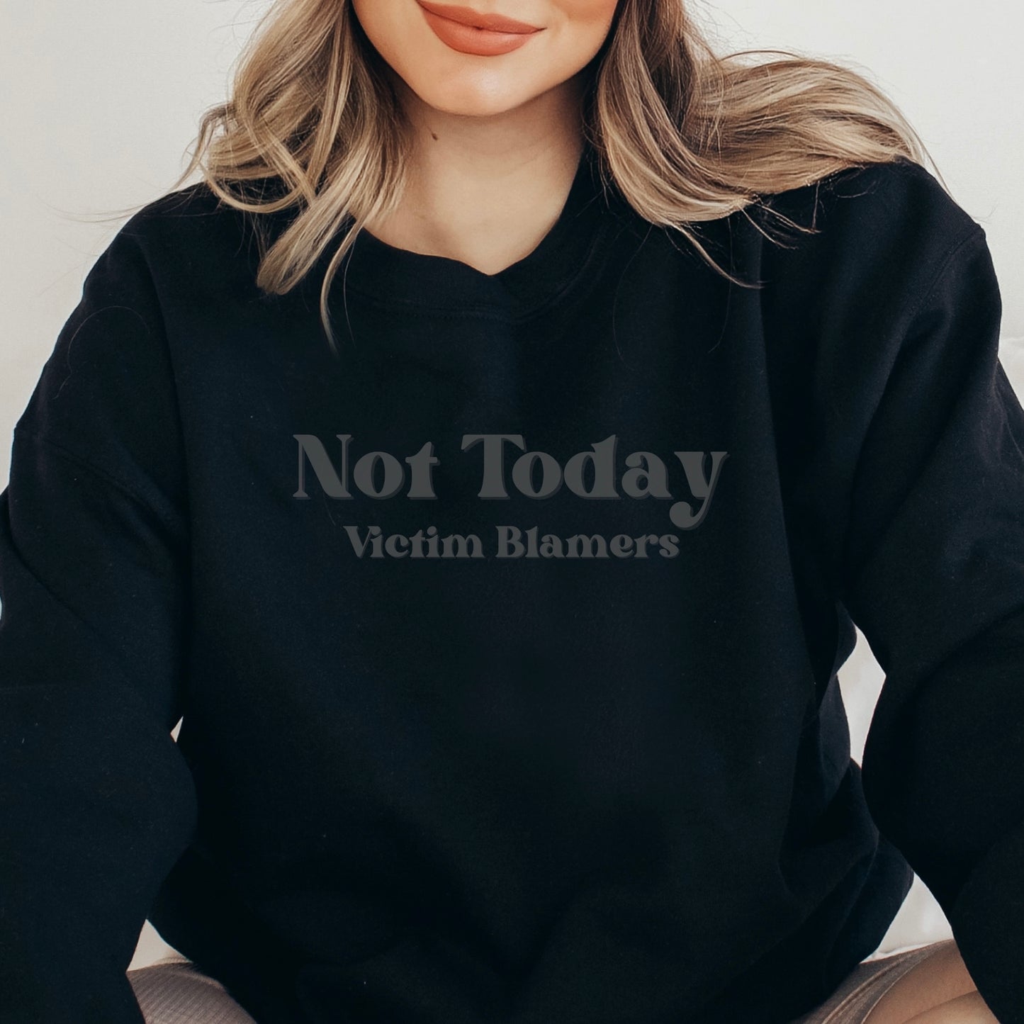The front of the sweatshirt proudly displays the phrase "Not Today Victim Blamers" in a bold and eye-catching font. This message serves as a reminder that we reject victim-blaming and support those who have faced injustice.